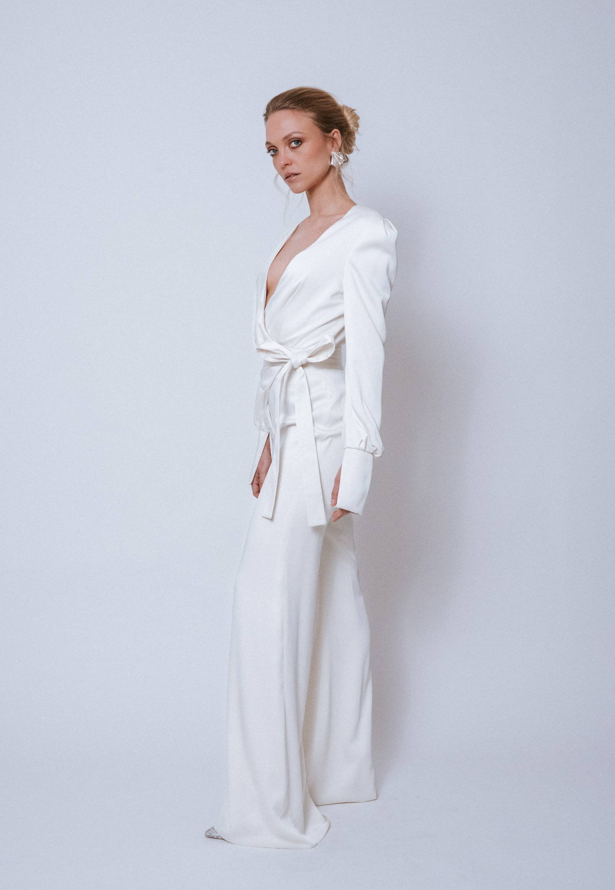 Side view of Freddie Jumpsuit Sample highlighting cache-coeur neckline and wide-leg flare