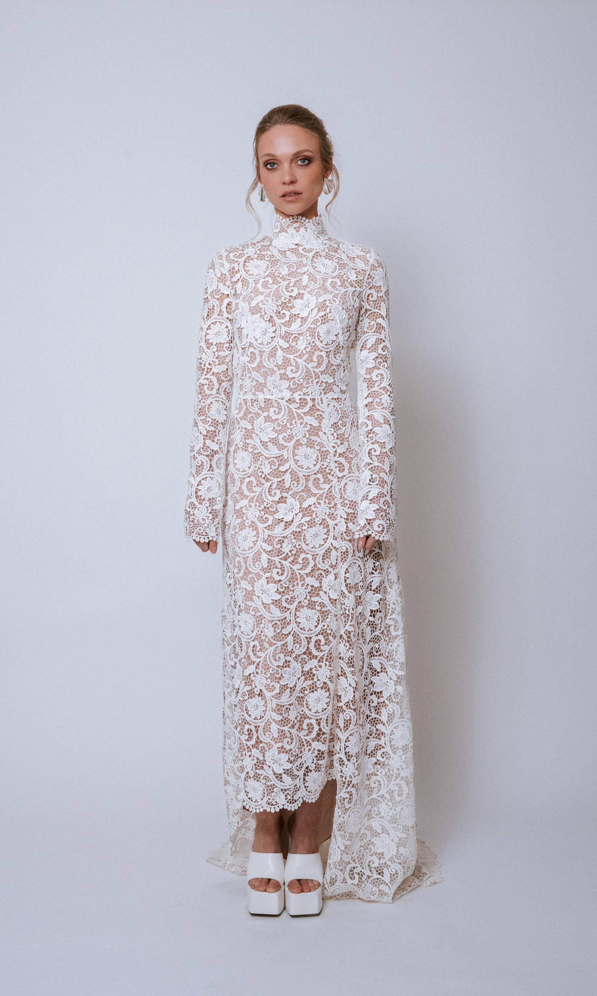 Front view of Valé Dress in ivory lace showing high neck, long sleeves, and A-line silhouette
