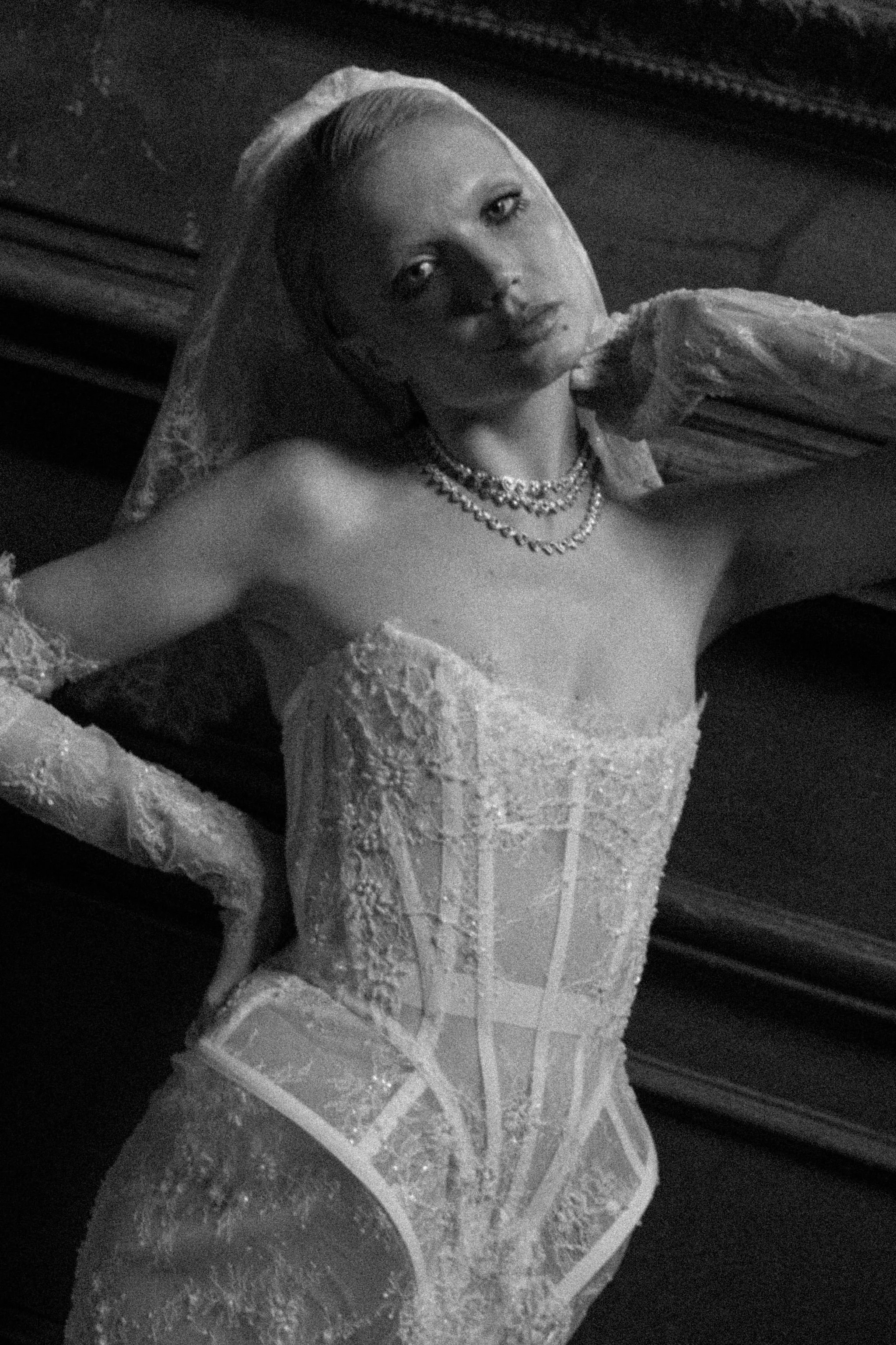 Close-up of a modern edgy wedding dress in lace highlighting the sharp cut and confident attitude
