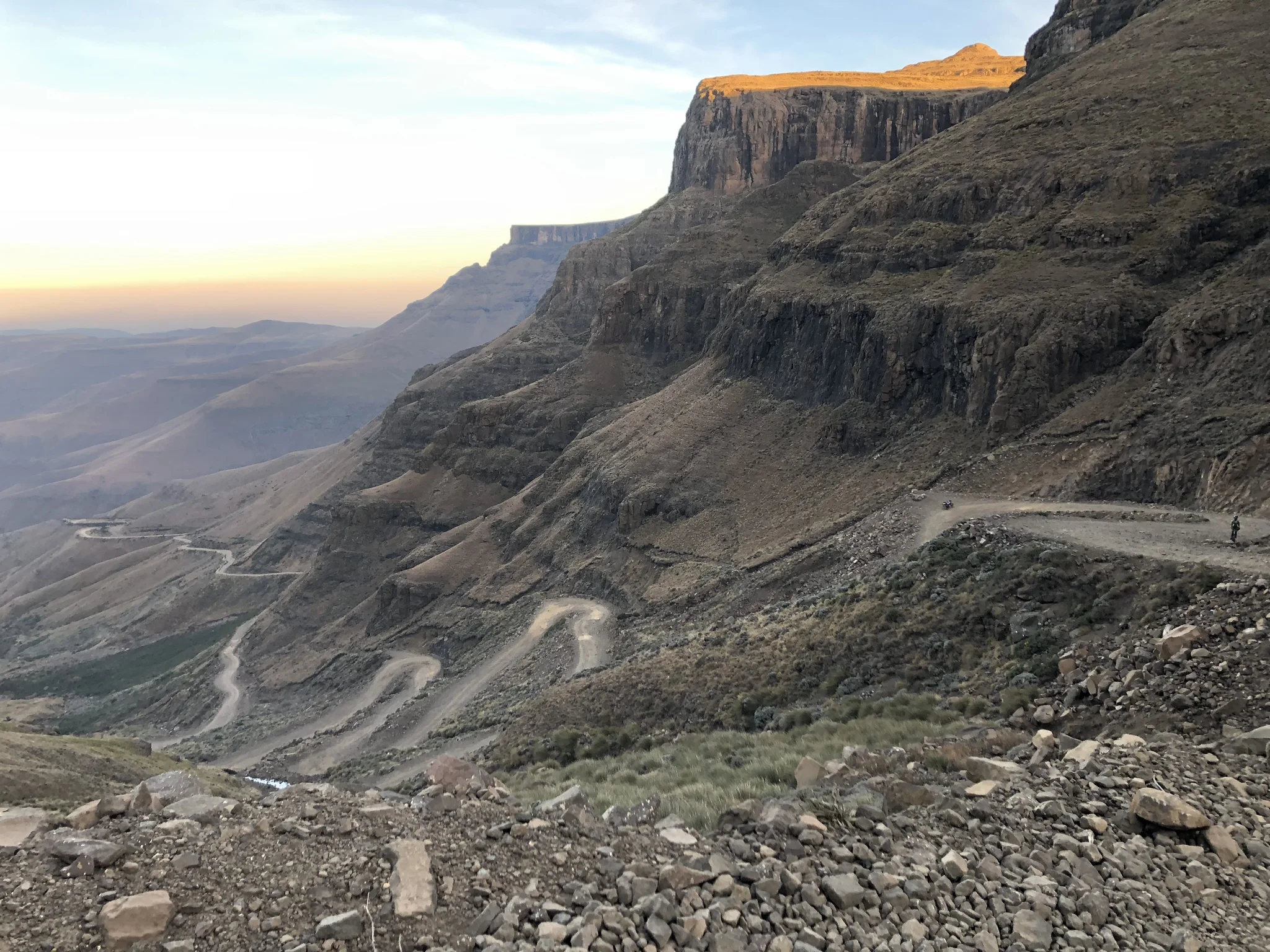  Iva hikes up the mountain, her bike in the background 