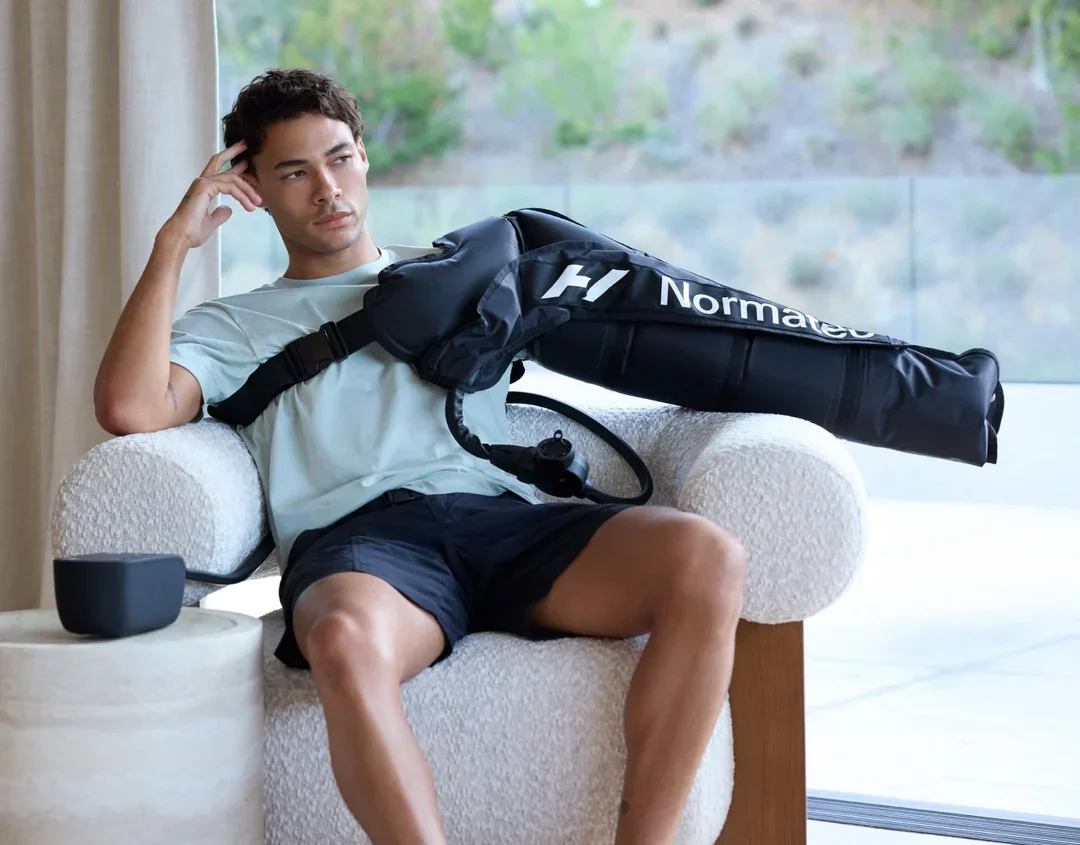 Man using Normatec on his shoulder
