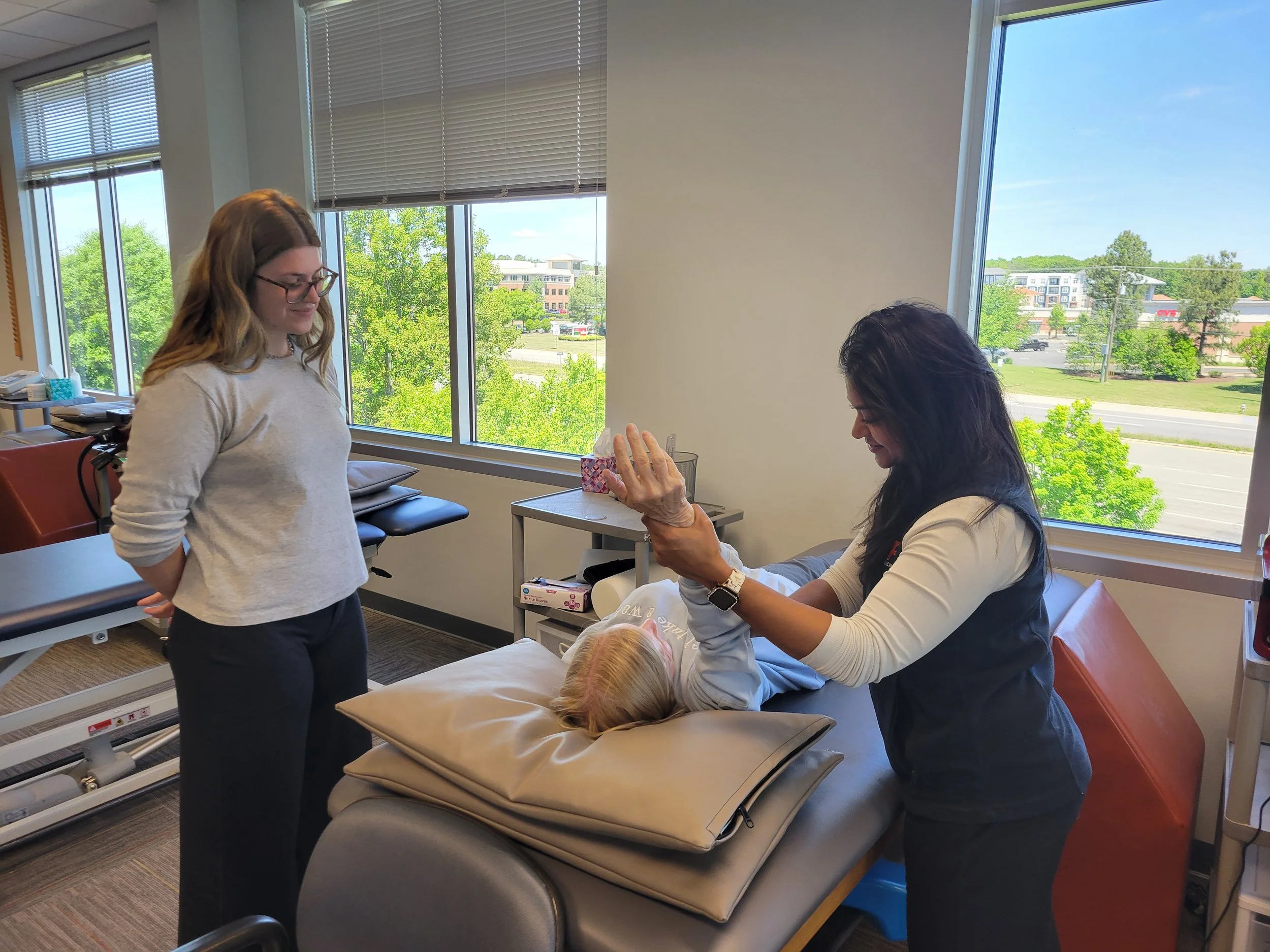 A student learning from a doctor of physical therapy