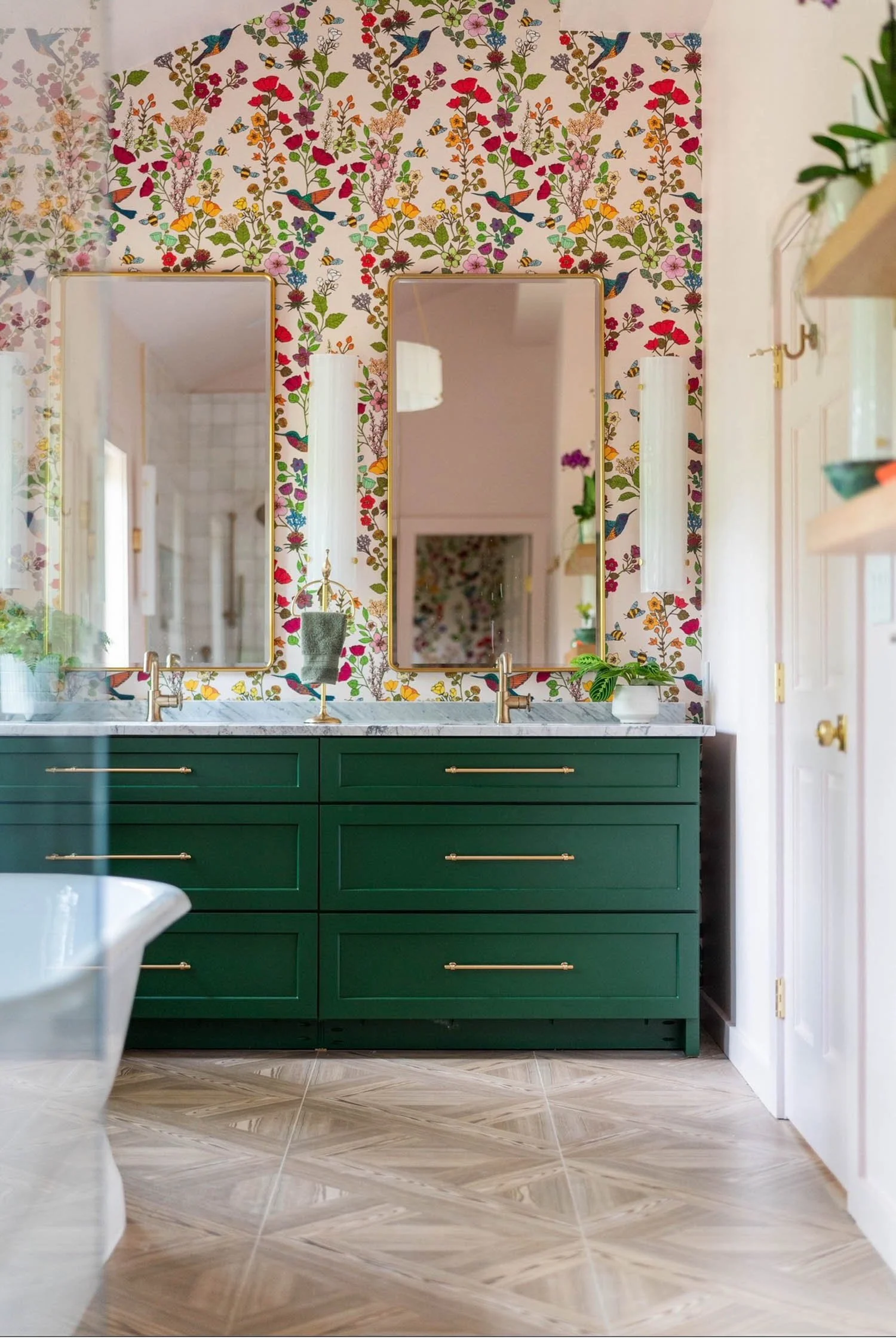 Custom green bathroom vanity cabinetry with floral wallpaper by Casey Eves Design & Build in Charlottesville, Virginia