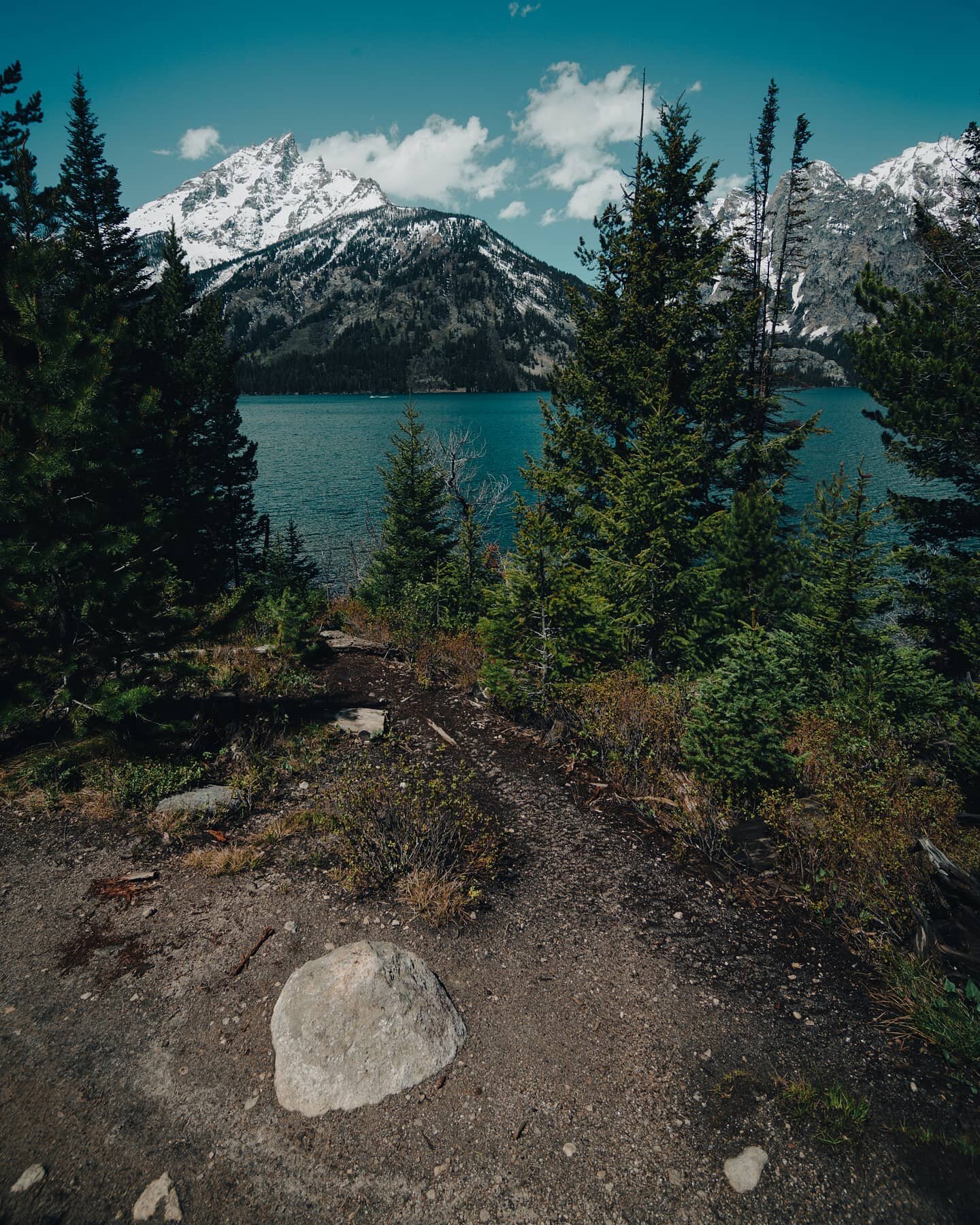 Here's a shot from the home around @grandtetonnps 's Jenny Lake. It's a beautiful sunny day here, but what you can't see is that a couple hours later, a monsoon-like rain (feat. Some Hail) pounded us on the last leg of the  hike. So glad I got to see