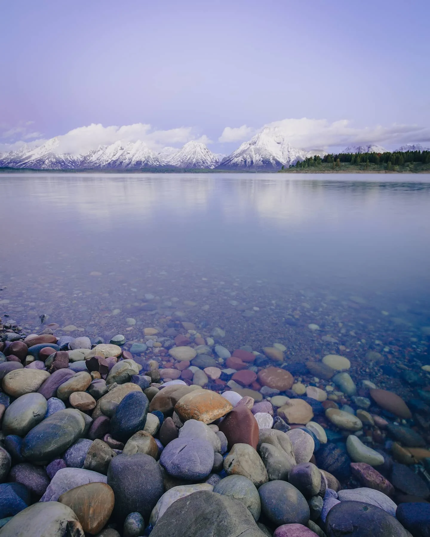 Because the spring is so unpredictable in @grandtetonnps, sometimes the best hope you have for a clear view of the range is getting up early. Here the mountains sit on the opposite side of Jackson Lake, basking in an early morning sun. The colors in 