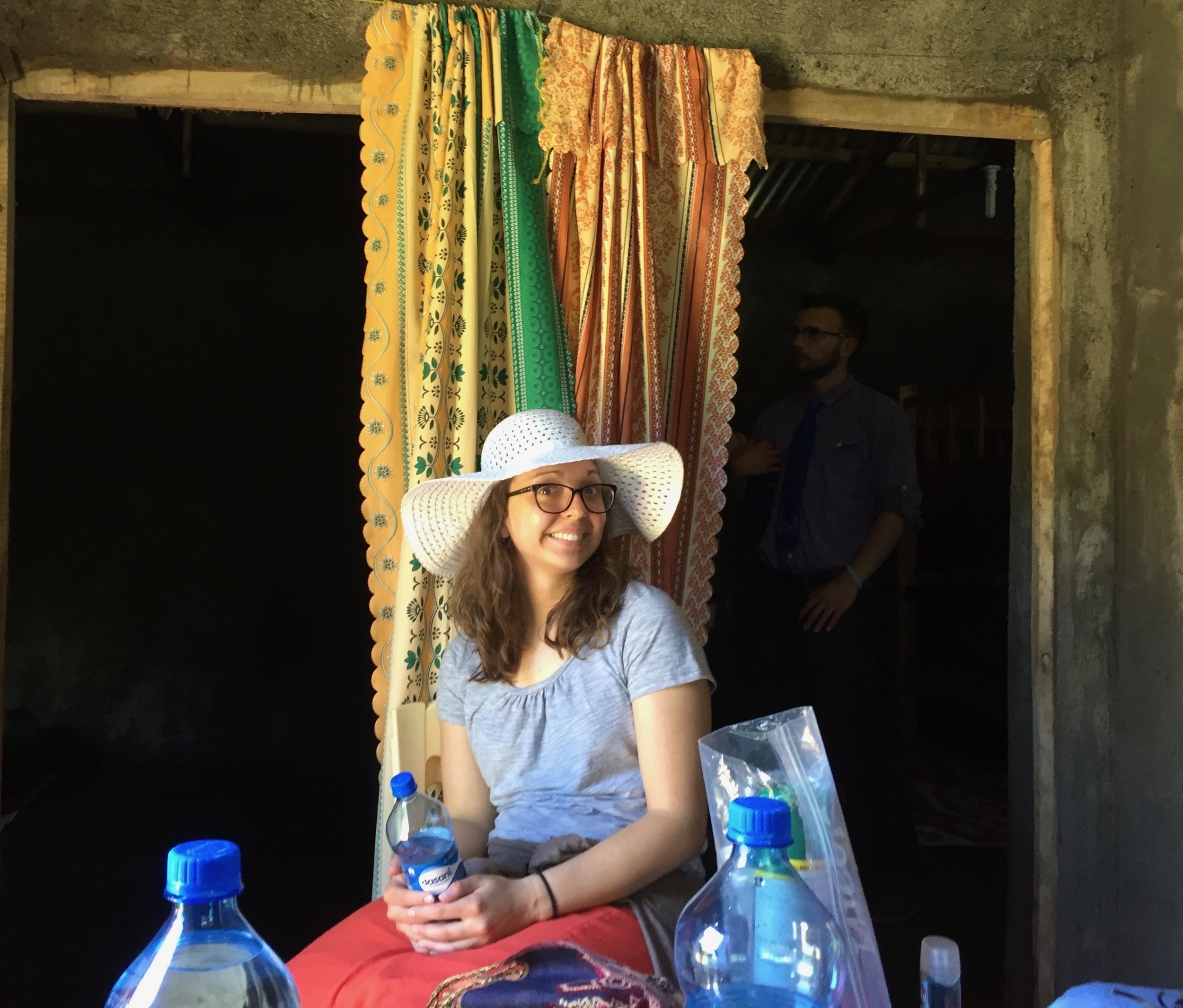  This was a quick snapshot from the first day in Kimilili of the inside of the chambre. To Natalie's right was the room that the girls stayed in, and to the left was the boys. The room that Natalie is in was the "living room" where the Open World tea