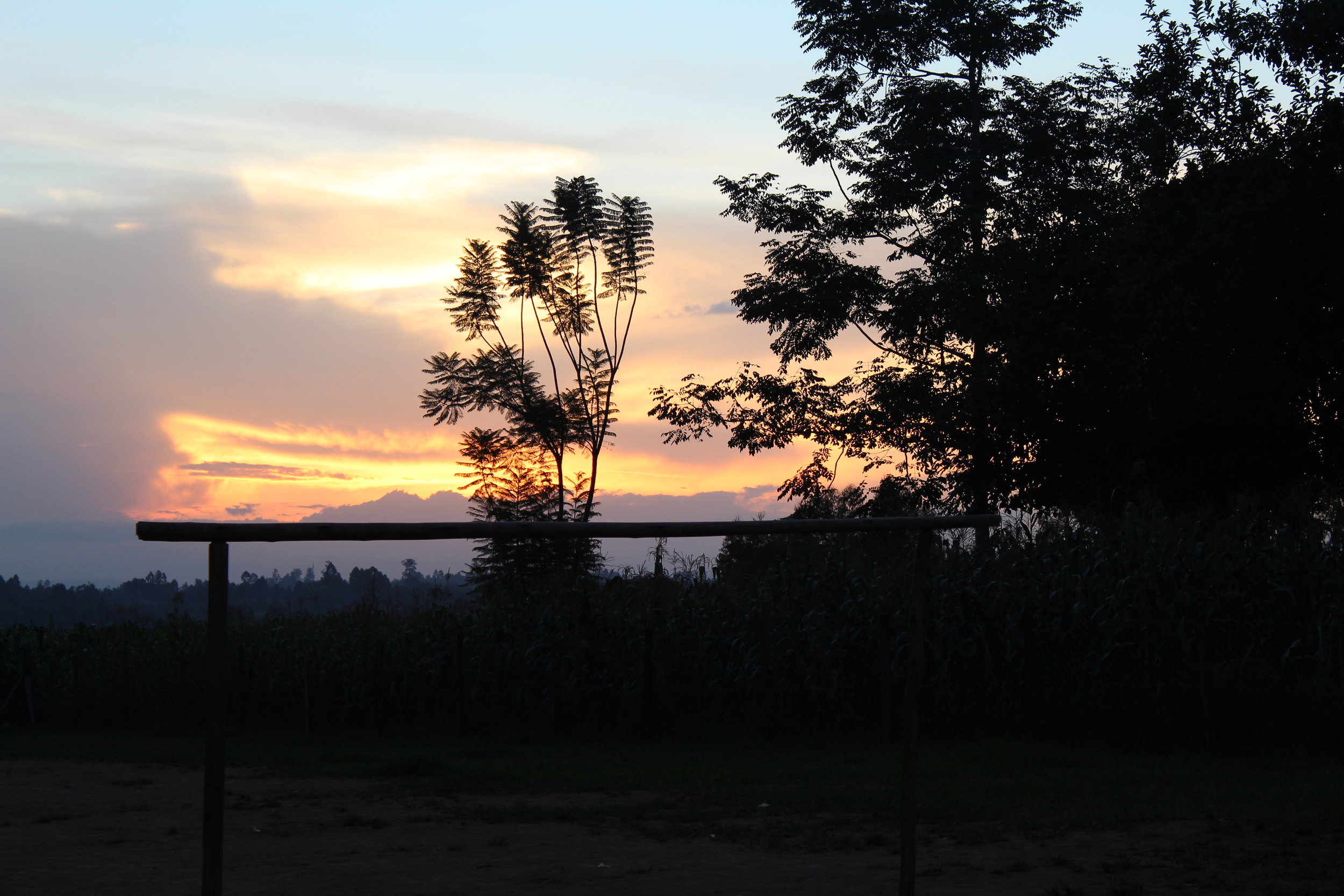  This sunset was from our first night in Kimilili, Kenya. You can see a few different staples from the community including a soccer goal post and corn growing in the fields. Several members of the community would play soccer in the evenings, and most