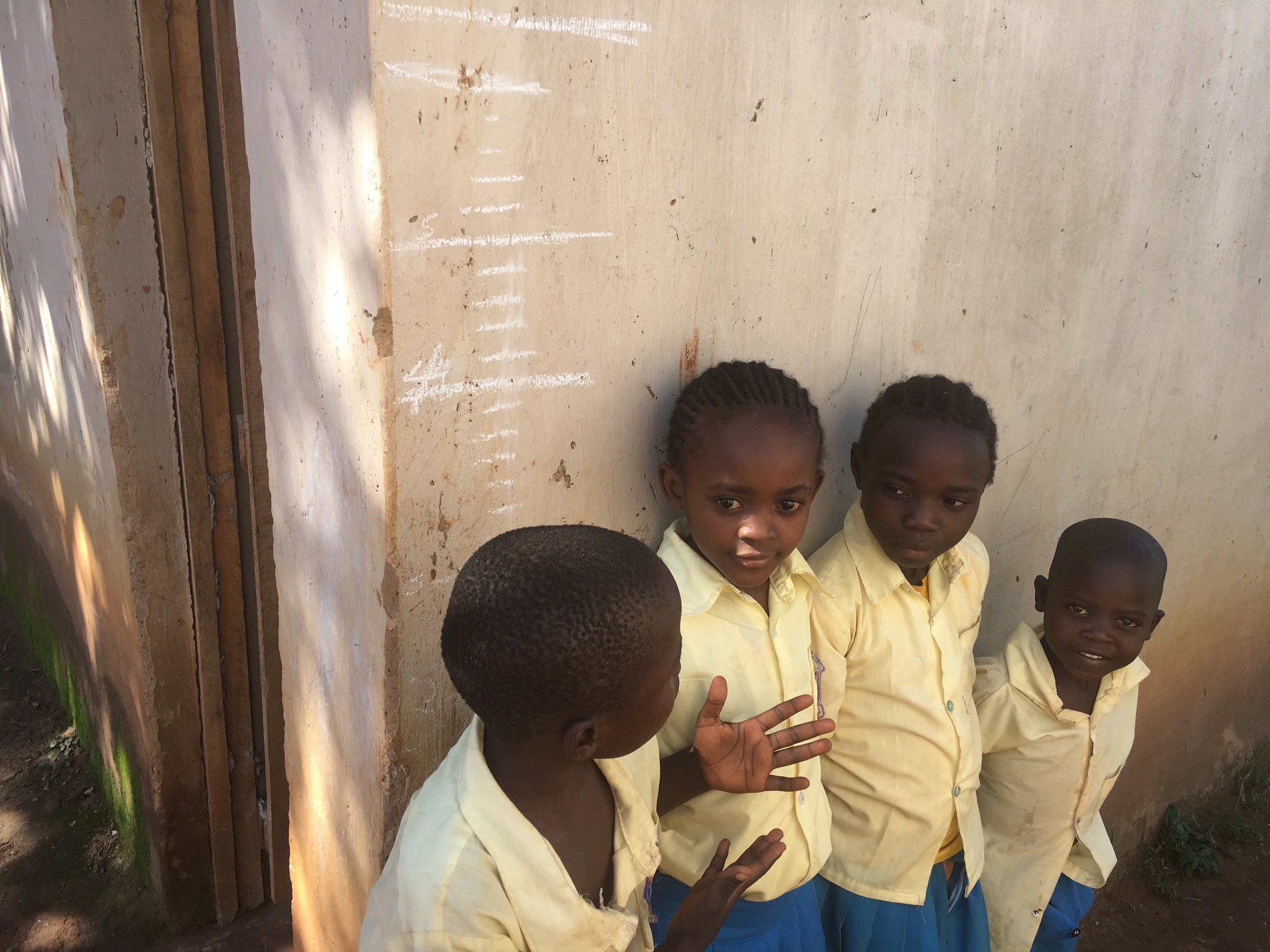 During recess, some of the kids wanted to stand next to each other and compare their height.