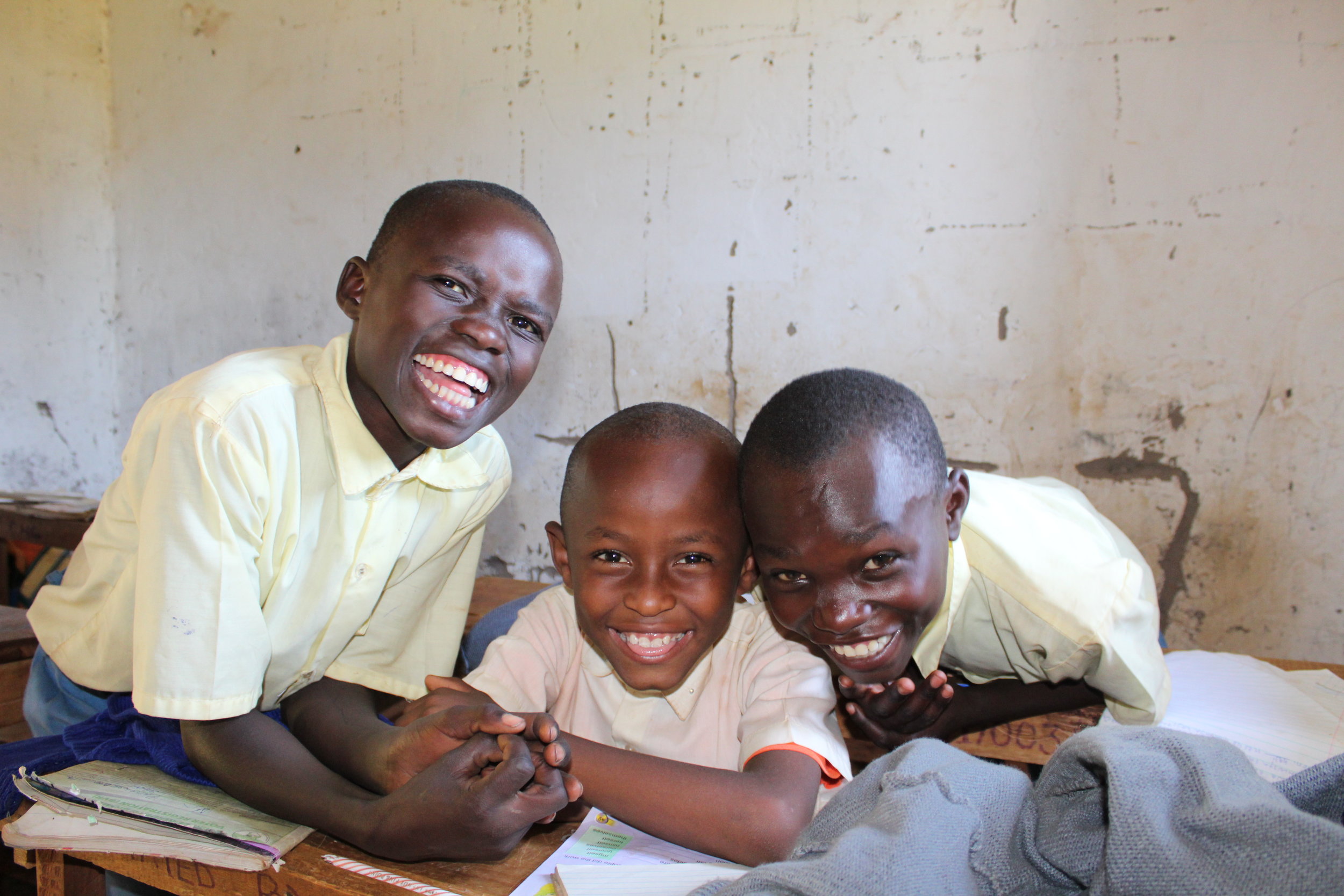 After recess, but before the teacher began her lesson, these three students took a quick second to try to make silly faces for the camera.
