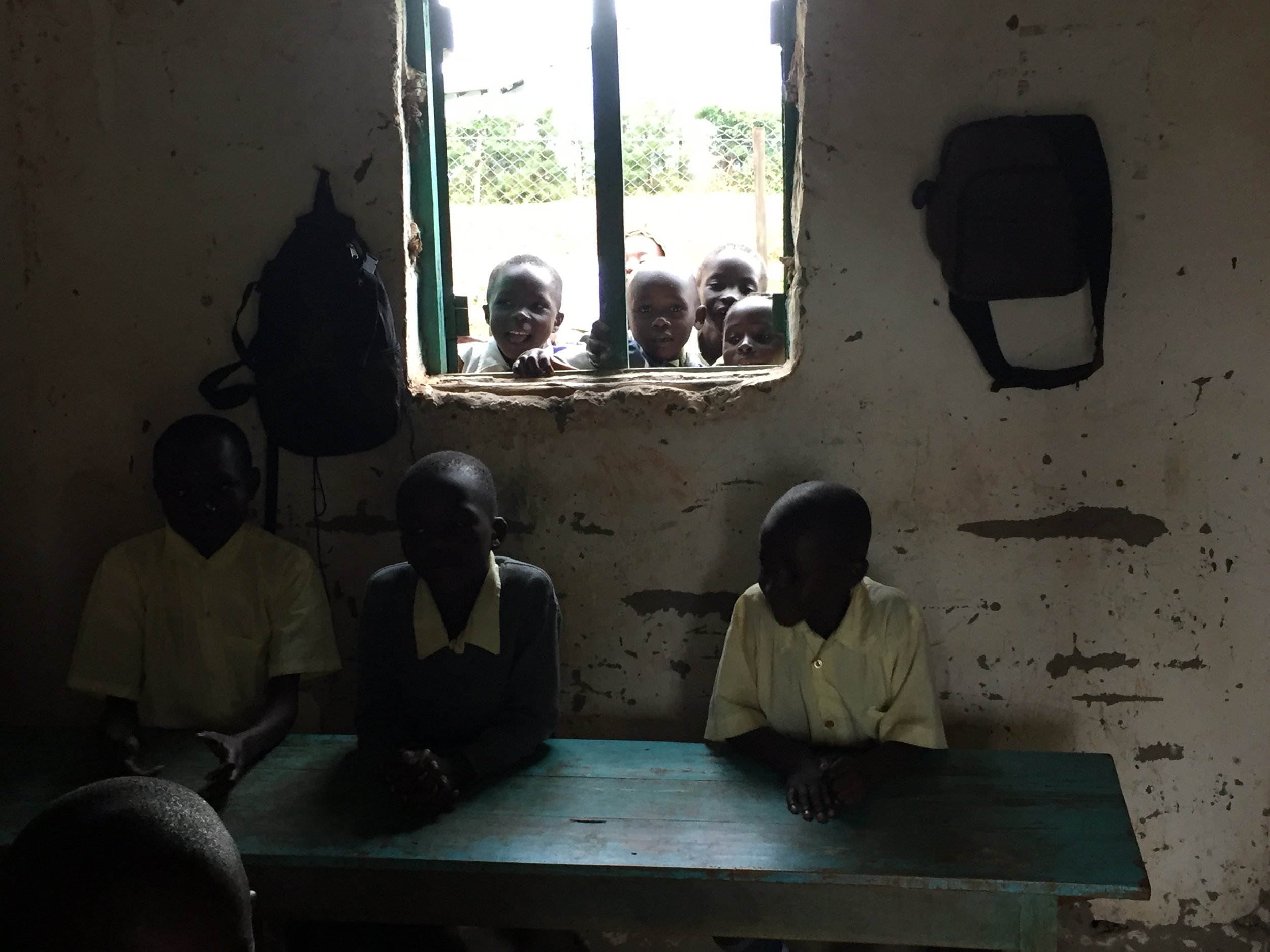  The classrooms were pretty small and had a single window. When the teacher wasn't instructing, students liked to gather in the windows to talk to their classmates in the rooms. 