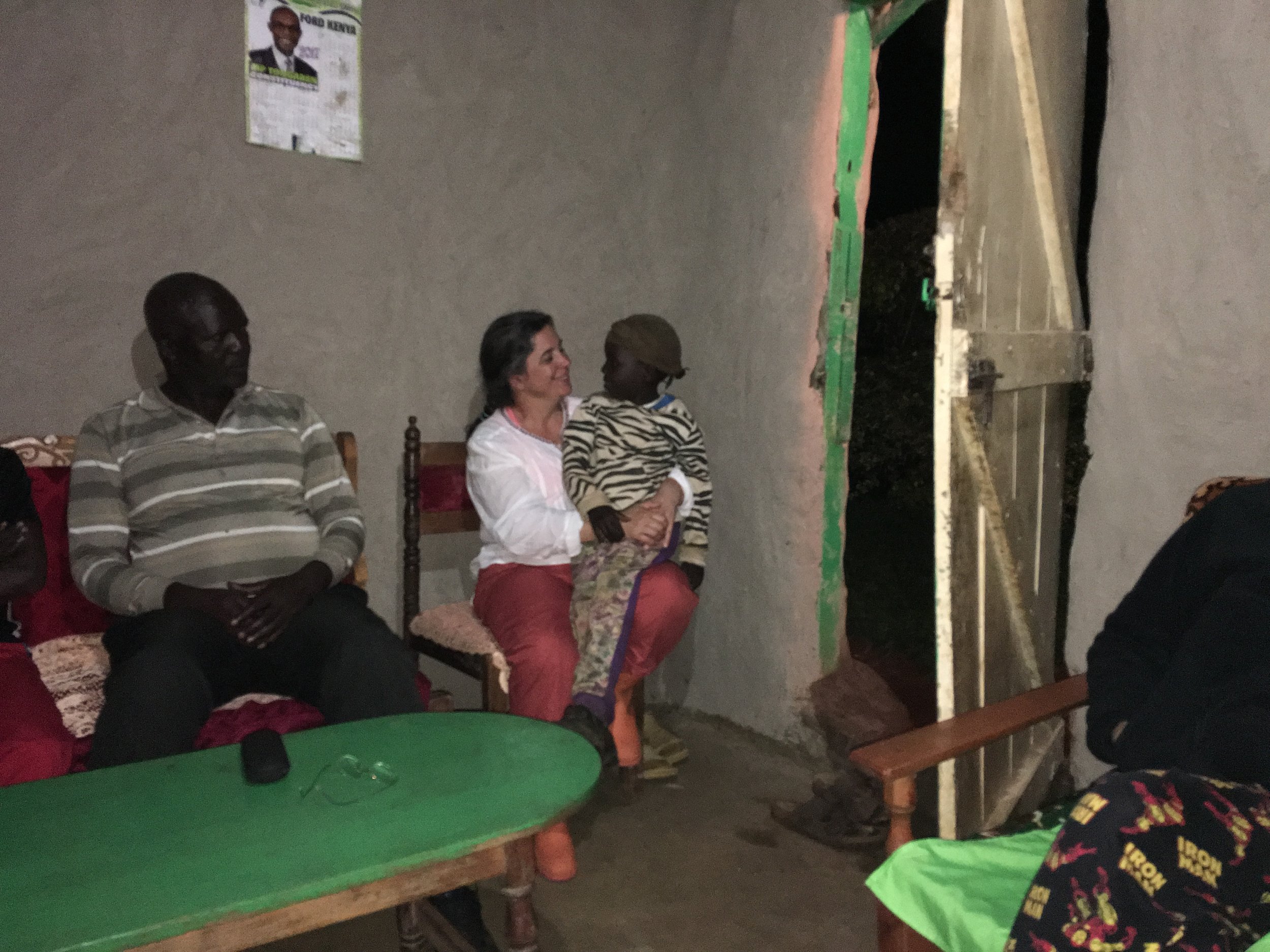  During our final dinner with the Kegode family, Livingstone's niece insisted on siting on Melissa's lap. 