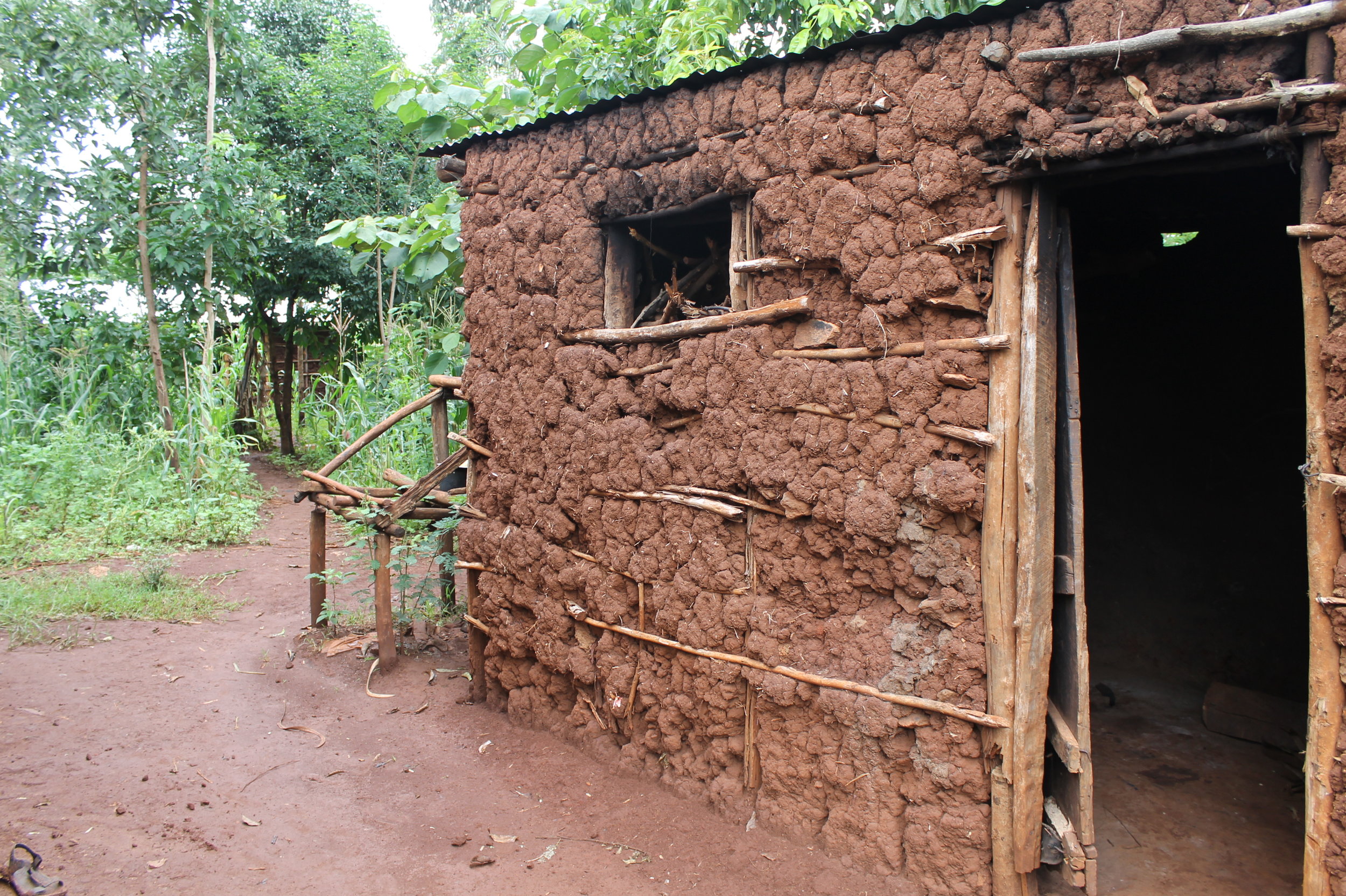 We loved this picture because it shows how much work goes into creating the houses in the Kimilili community. First, a wooden frame must be constructed, and then it must be packed with a mixture of mud and hay.