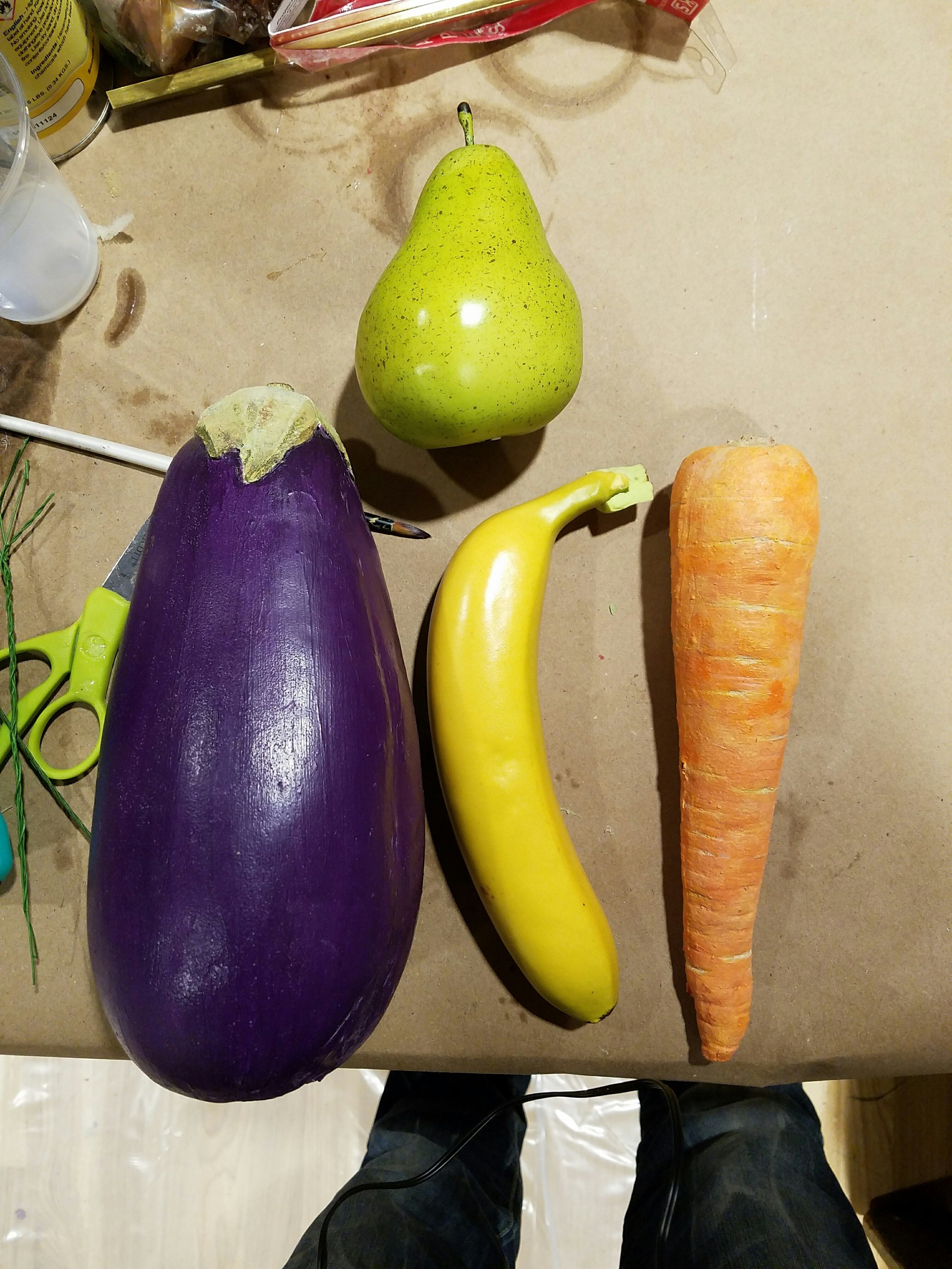 A real eggplant and carrot were molded, and then cast using urethane foam, and painted up to look like the real thing