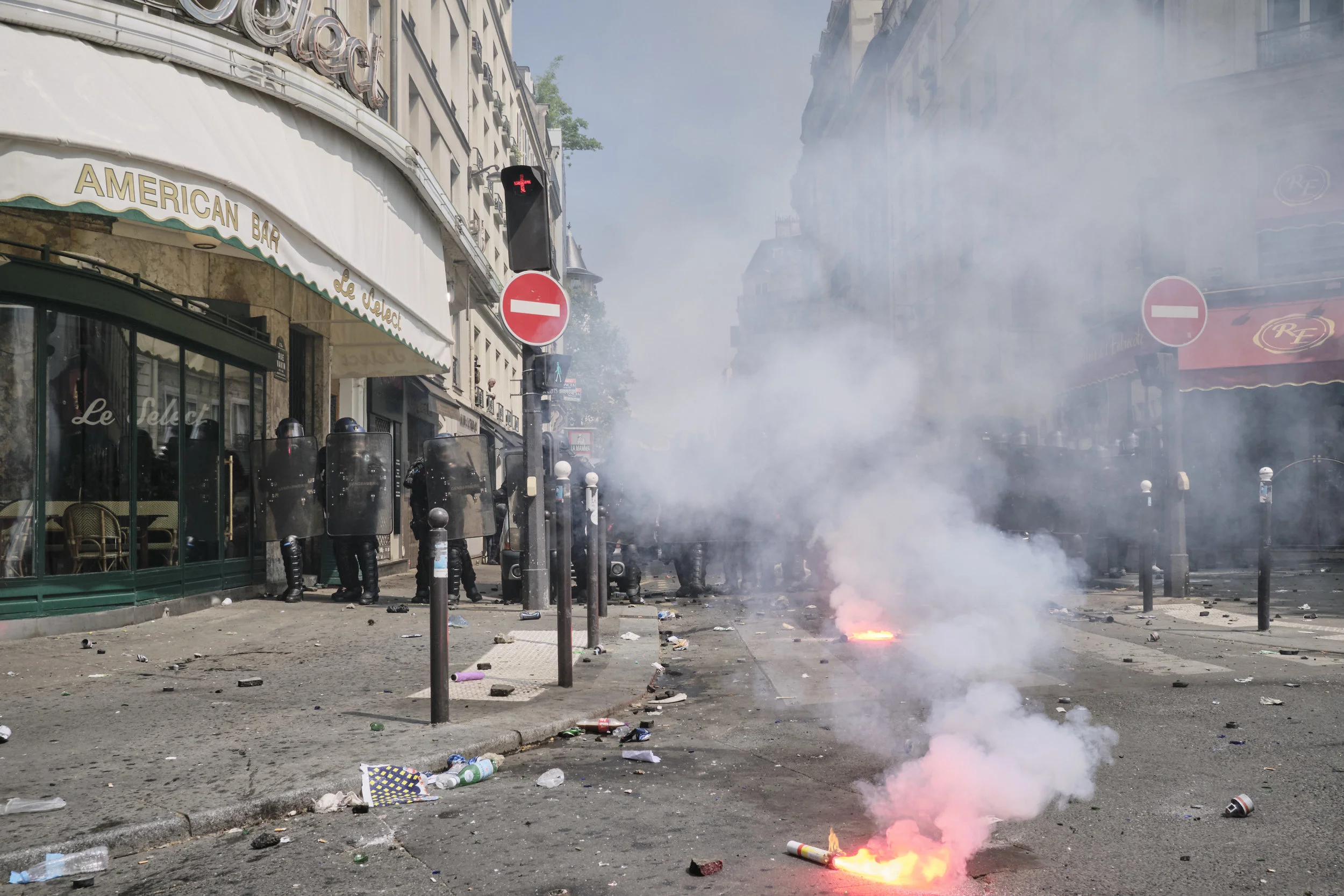 Light flairs burning after a confrontation between the protesters and the police at Boulevard du Montparnasse.