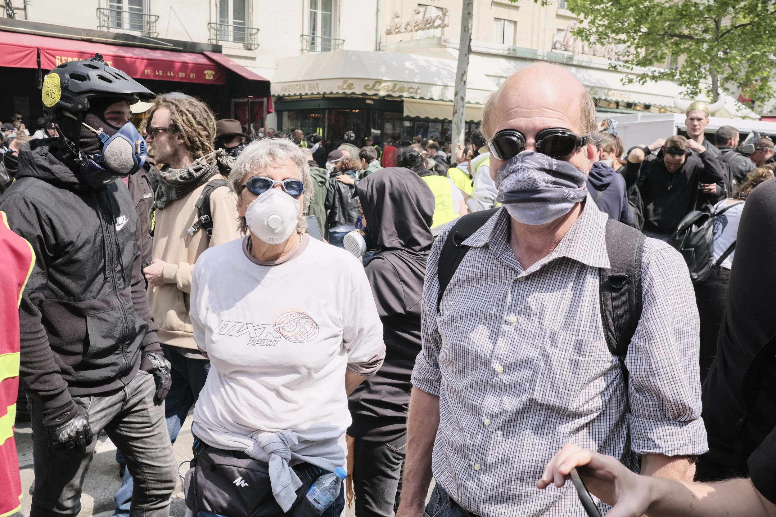 An elderly couple of protest participants with their makeshift protective equipment from the tear gas at Boulevard du Montparnasse.