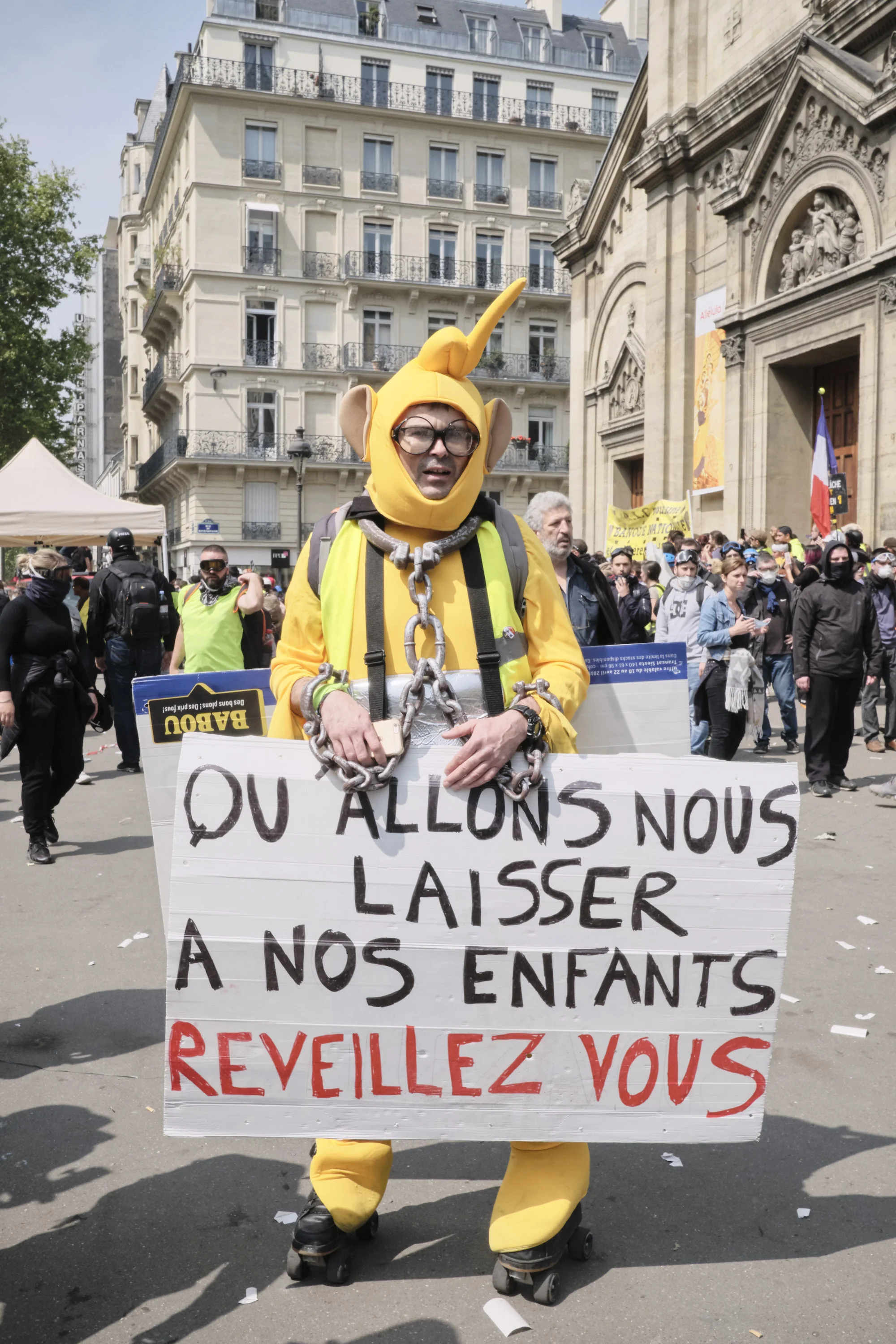 Protester holding a sigh “What are we going to leave our children to wakeup to”.