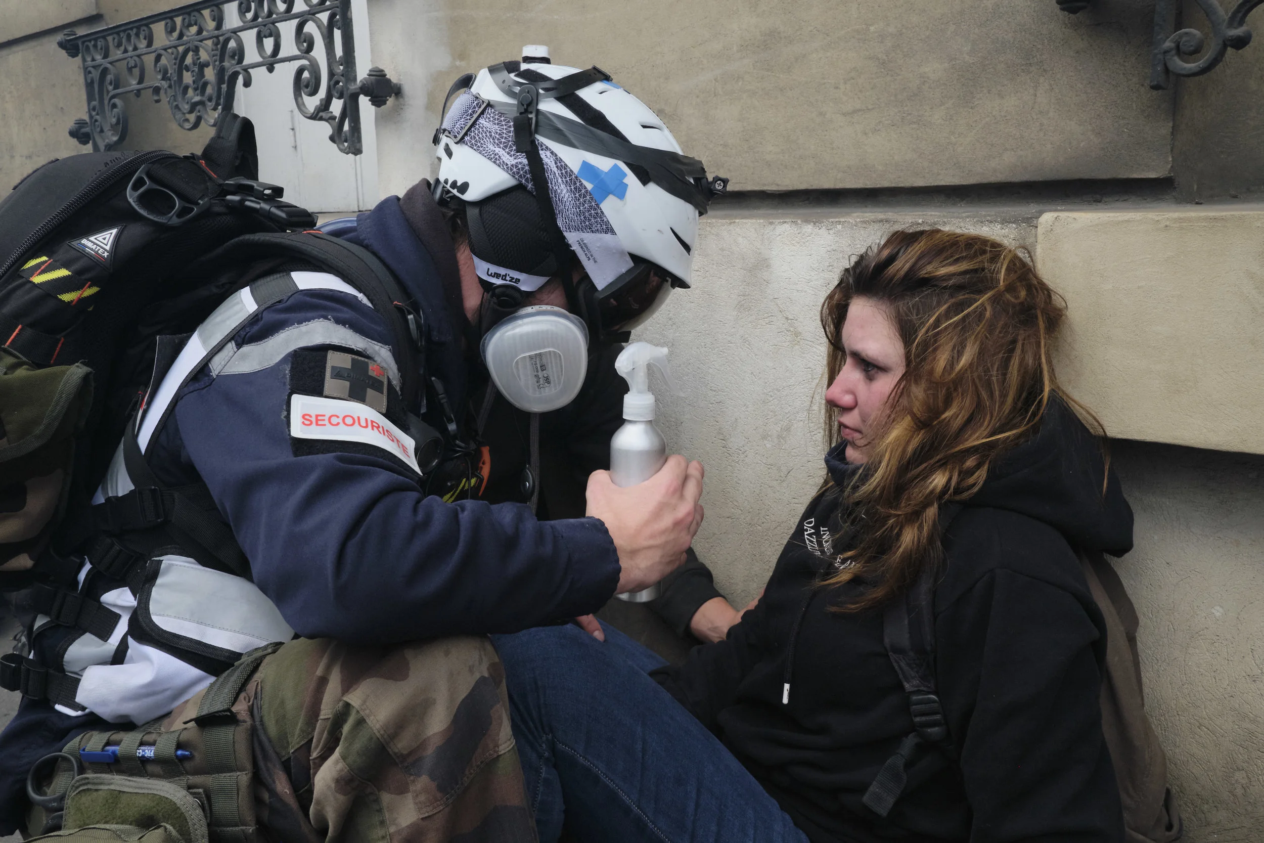 Street Medics helping an injured protest participant after a confrontation with the police.