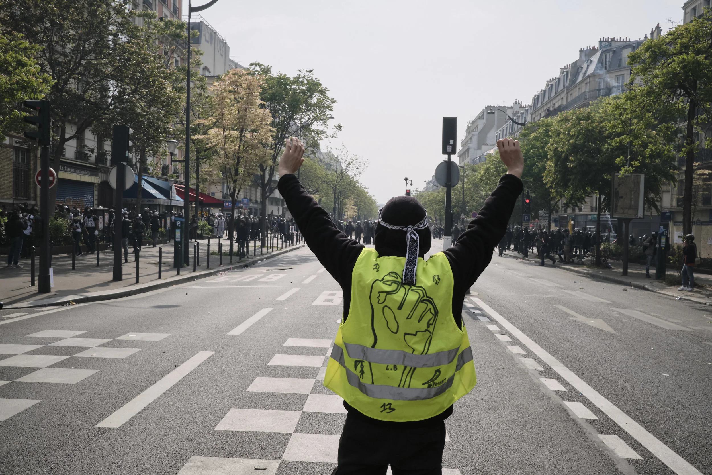 Yellow vest participant standing in front of police at The Boulevard Argo during the march to The Place D’italie.