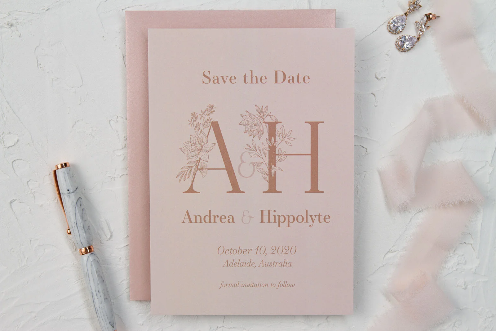 Save the Date card with prominent monogram and florals, personalized names, date, and location of your wedding.