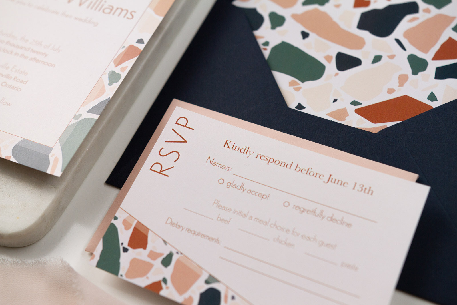 Detailed look at the reply card with terrazzo section and personalized options for guest rsvp and dinner choices.