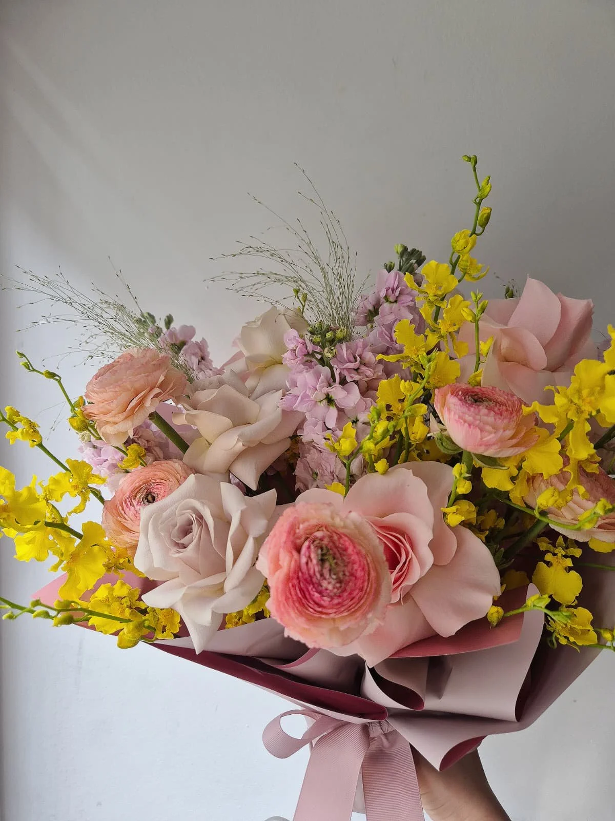 oncidiums roses and ranunculus.jpeg