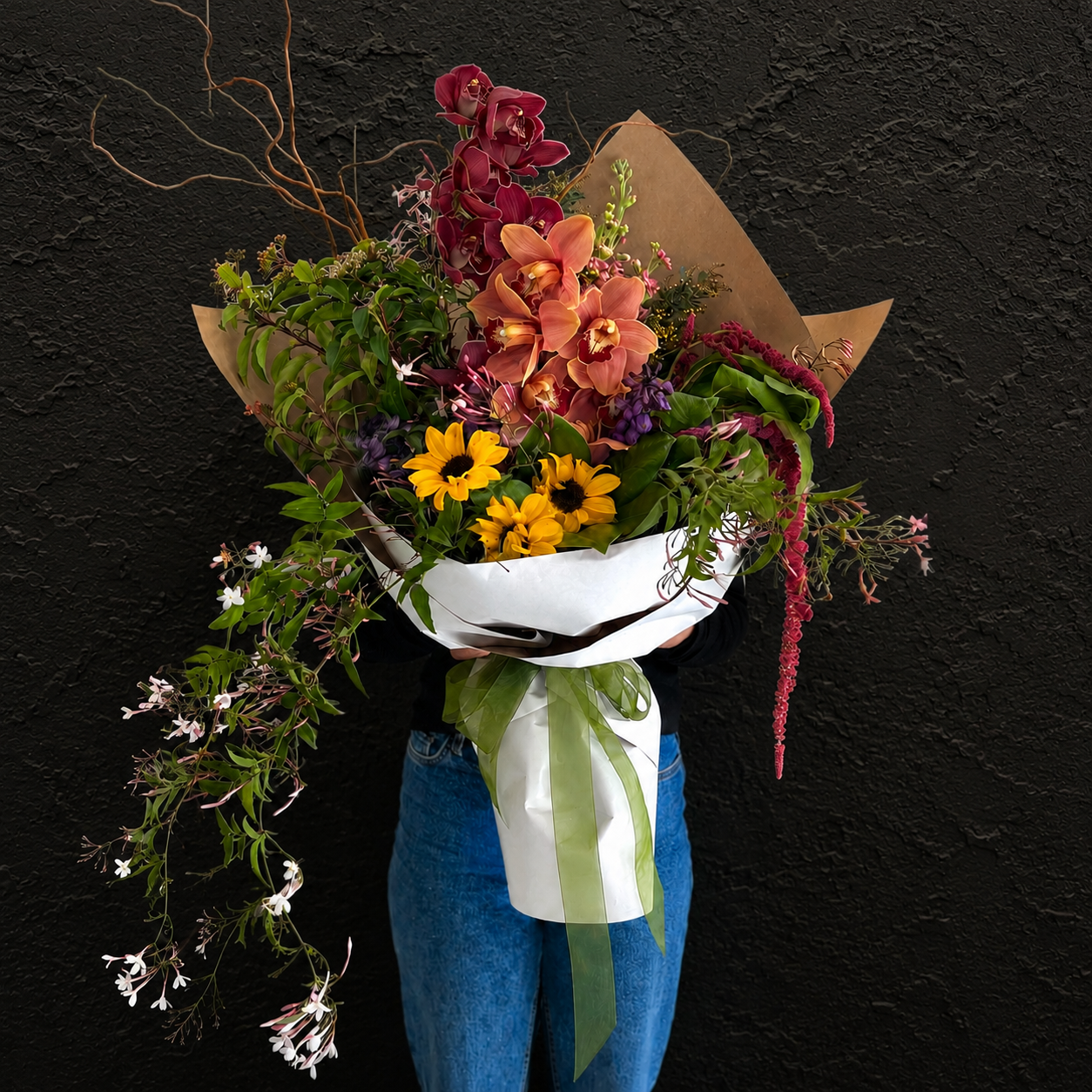 wrapped Ōtaki Bouquet featuring exotic flowers, orchids, sunflowers and wild seasonal foliage by Love Stomp Floral