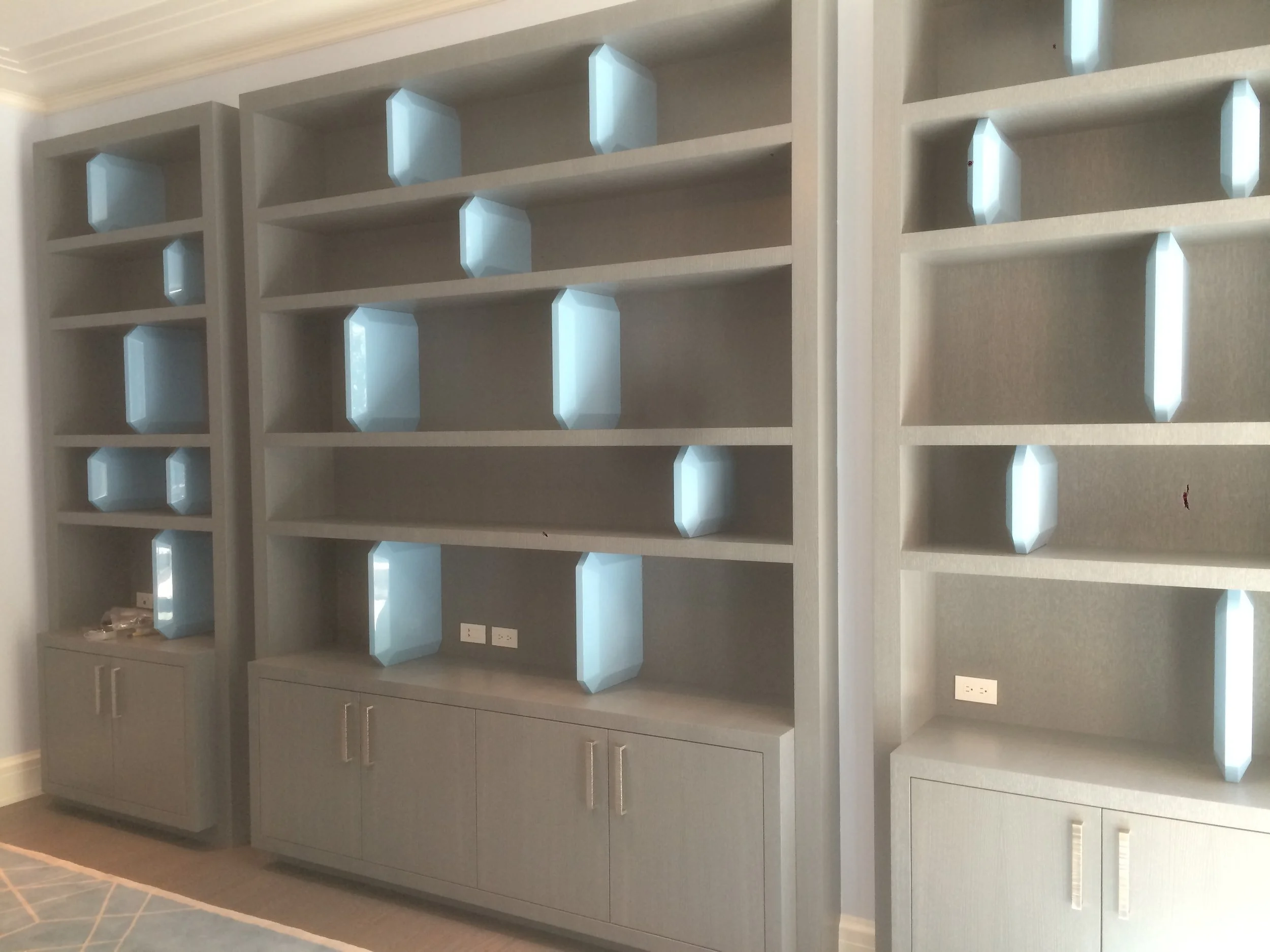 Our custom bookcase has lacquered shelf dividers inspired by cut diamond shapes.