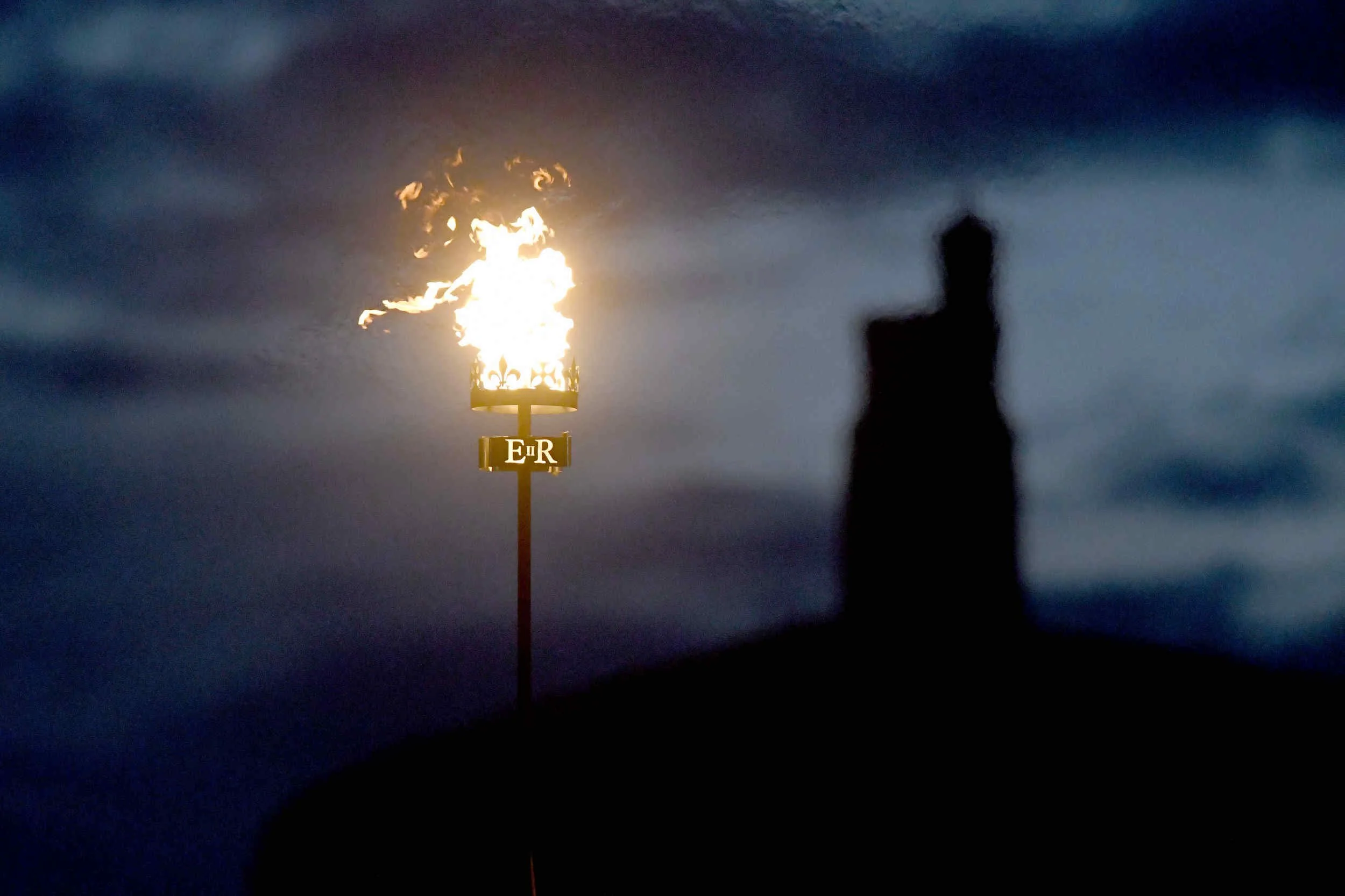  A beacon is lit on the Raglan Pier to mark the Platinum Jubilee of Queen Elizabeth II - pictured with MilnerÕs Tower in the background 