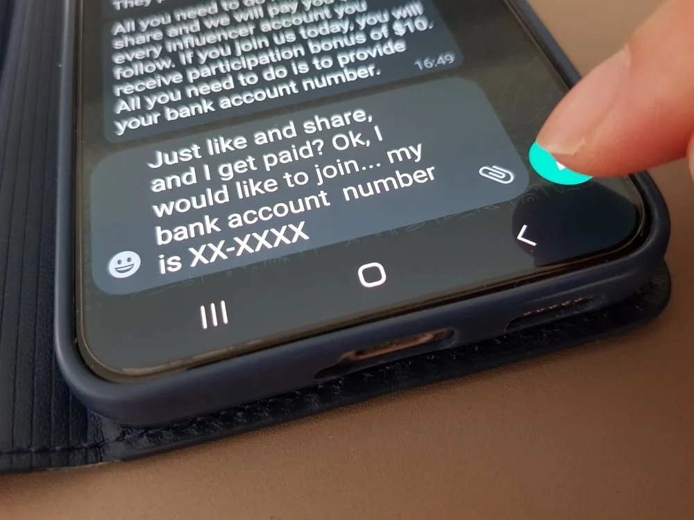 A phone keyboard displays text related to a common financial scam