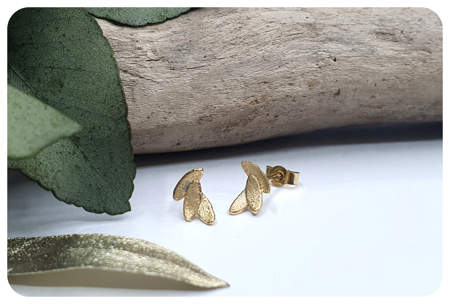 tiny gold leaves studs with scroll.png