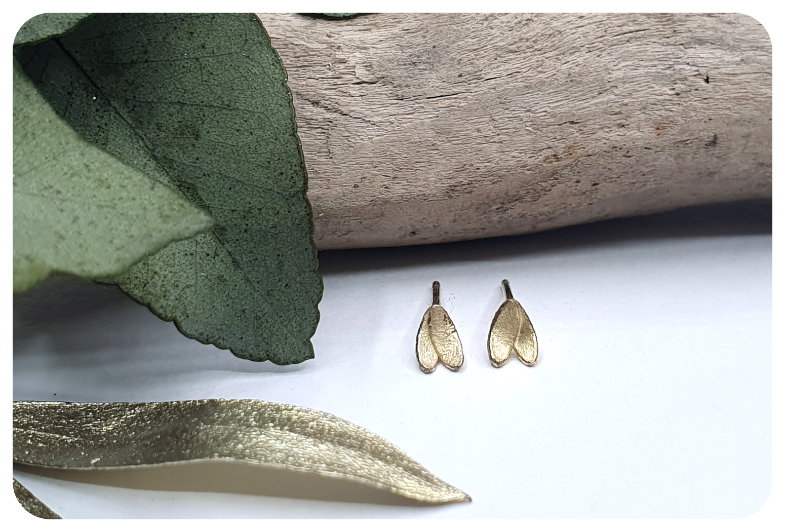 tiny gold double petal earrings.png