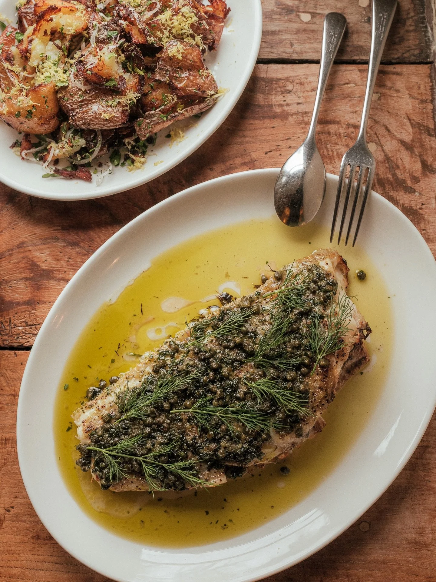 A lovely one from the weekend just gone. Whole Plaice, on a bed of lemon and herbs, roasted hard and fast and then rested. Finished with a lemon and caper butter then served with some smashed pink fir potatoes.

A proper serving of fish and chips to 