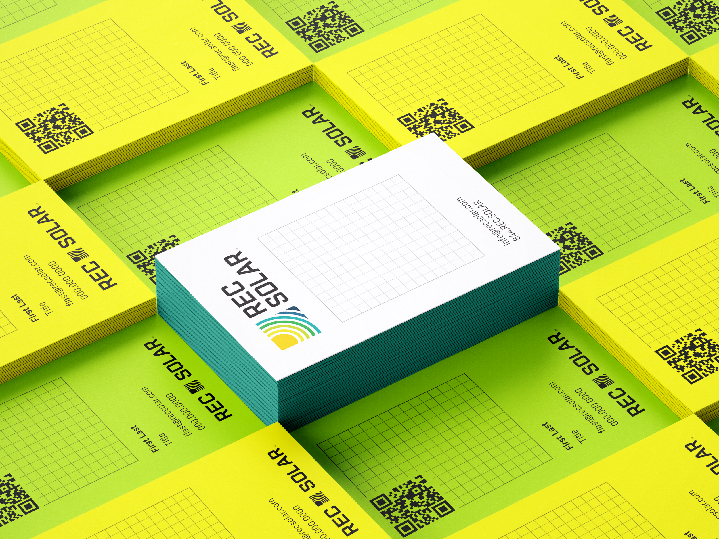 A photo of stacks of business cards. There is a tall stack of white cards with 4 color printing in the center. It is surrounded by smaller stacks of 1 color printed cards, alternating neon green and neon yellow.
