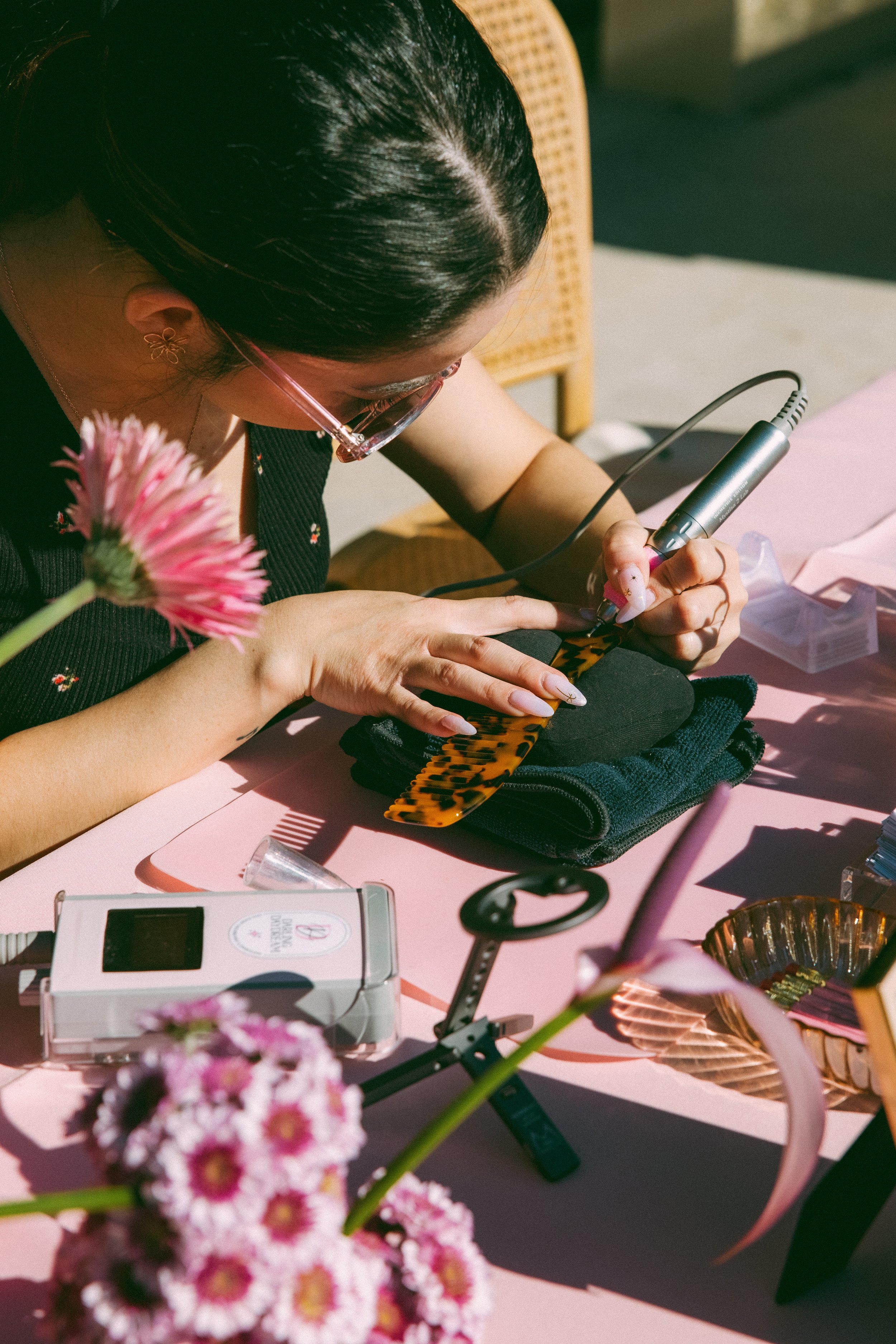 a tortoise shell comb being hand engraved on a table
