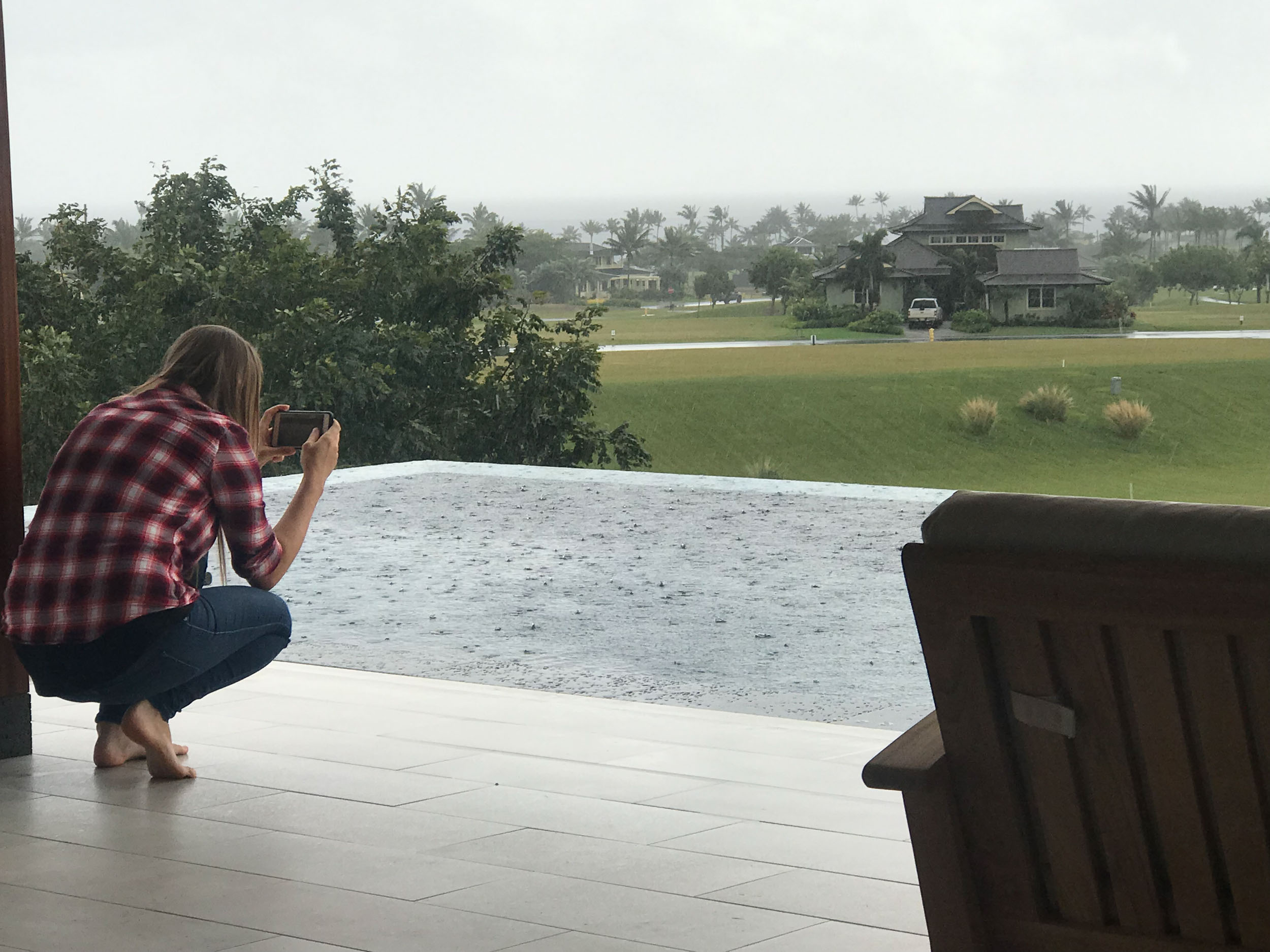 Anna my assistant taking pictures of the rain on our last half day at the house. 