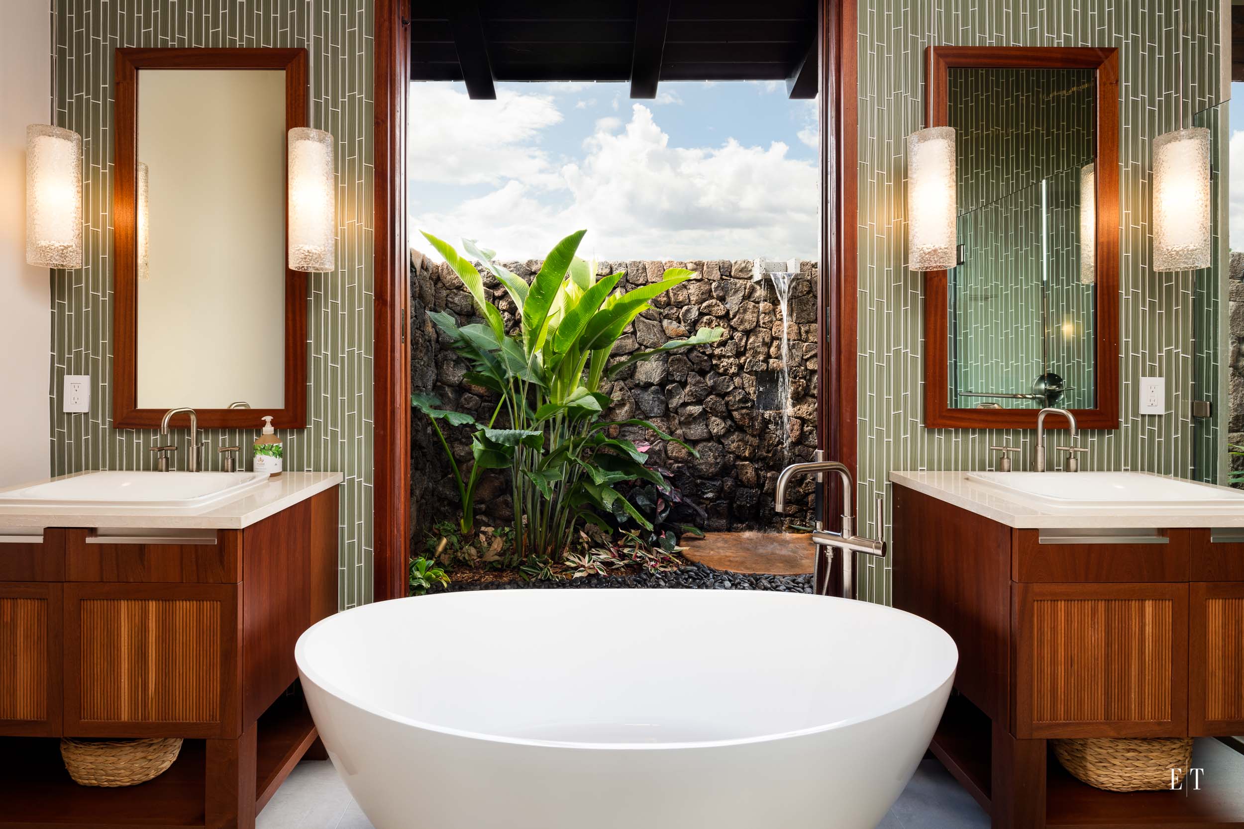 This tub has a view of the outdoor garden and shower