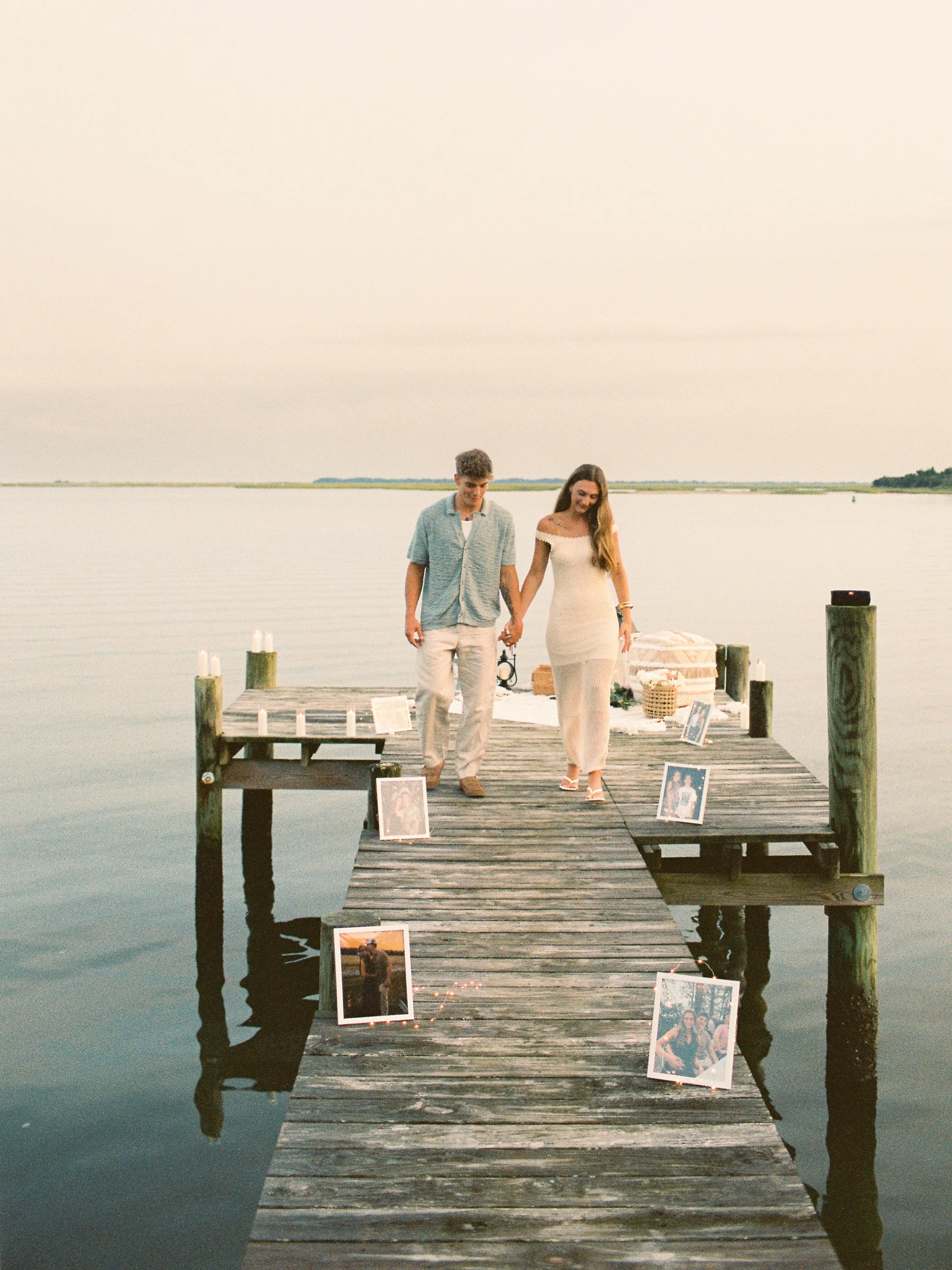 She thought they were going to dinner. Meanwhile, this was waiting for her 🥹 

Nick had every little detail planned for the sweetest surprise proposal on the water in Swansboro, North Carolina. A dock lined with photographs from their story, candles