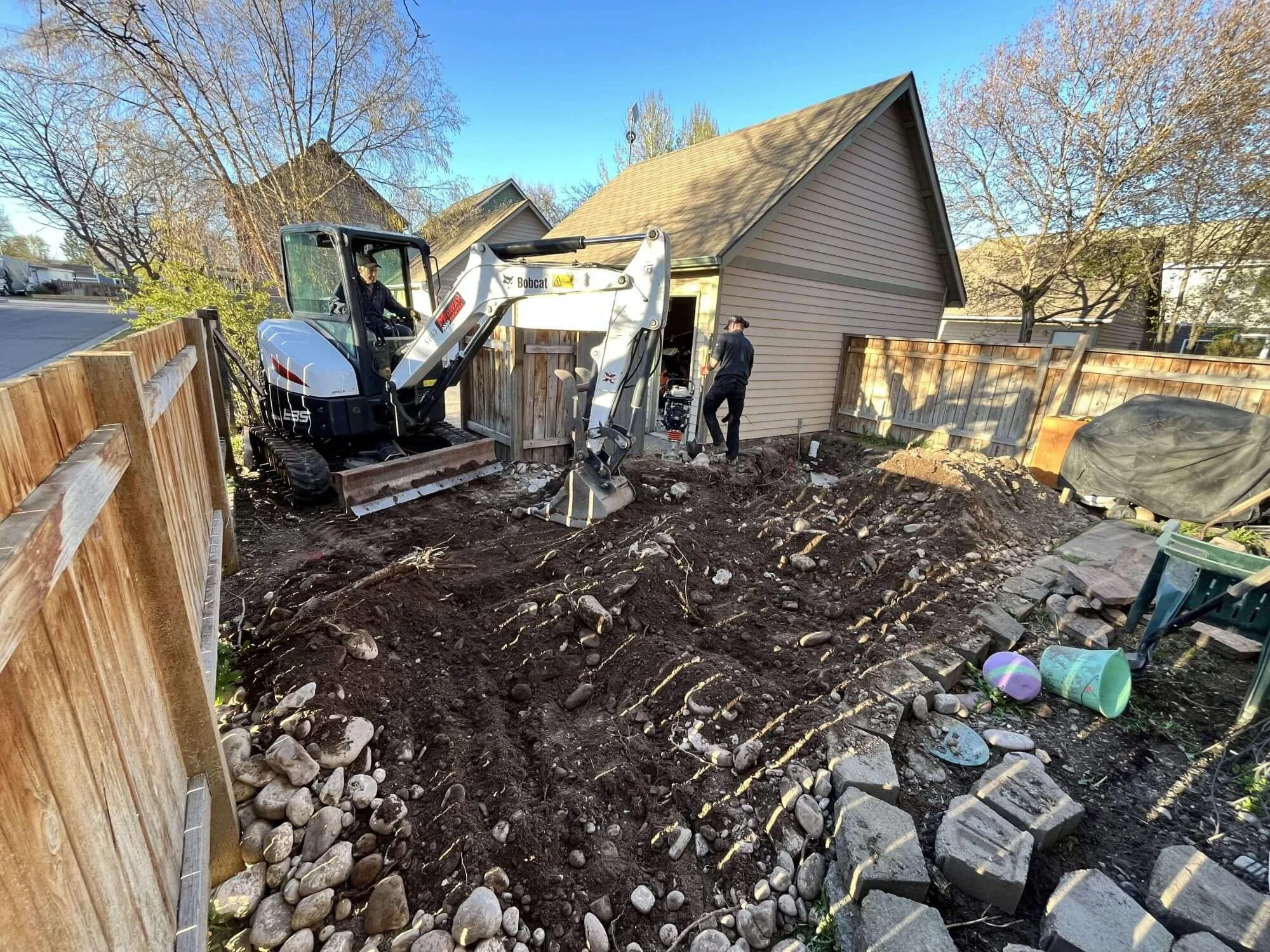 Groundwork is underway to level the backyard surface for a new decking project in Seattle.