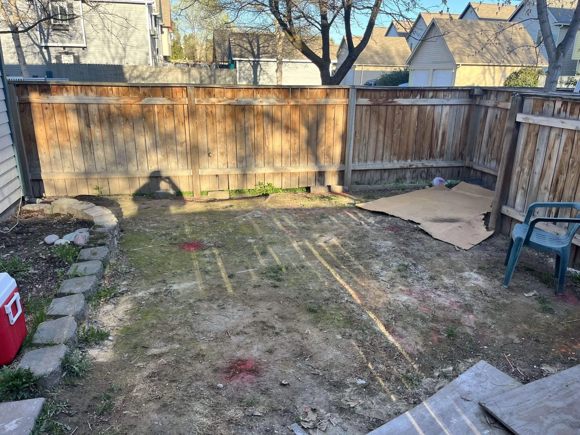 The Gold Mountain Contracting crew is taking photos of a Ballard backyard in Seattle to prep for a new deck build.