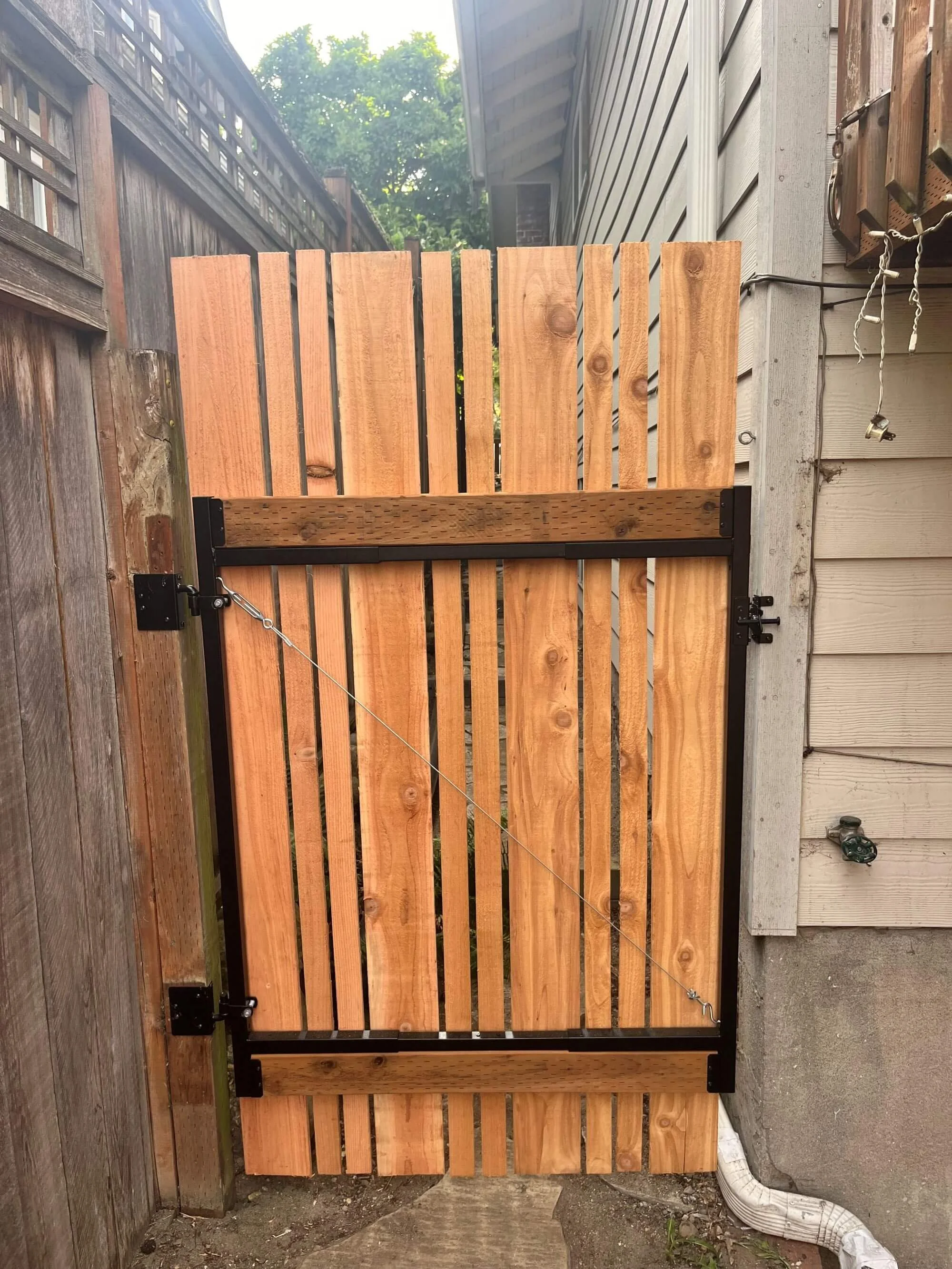 New custom cedar gate designed and installed by Gold Mountain Contracting for a Seattle homeowner.