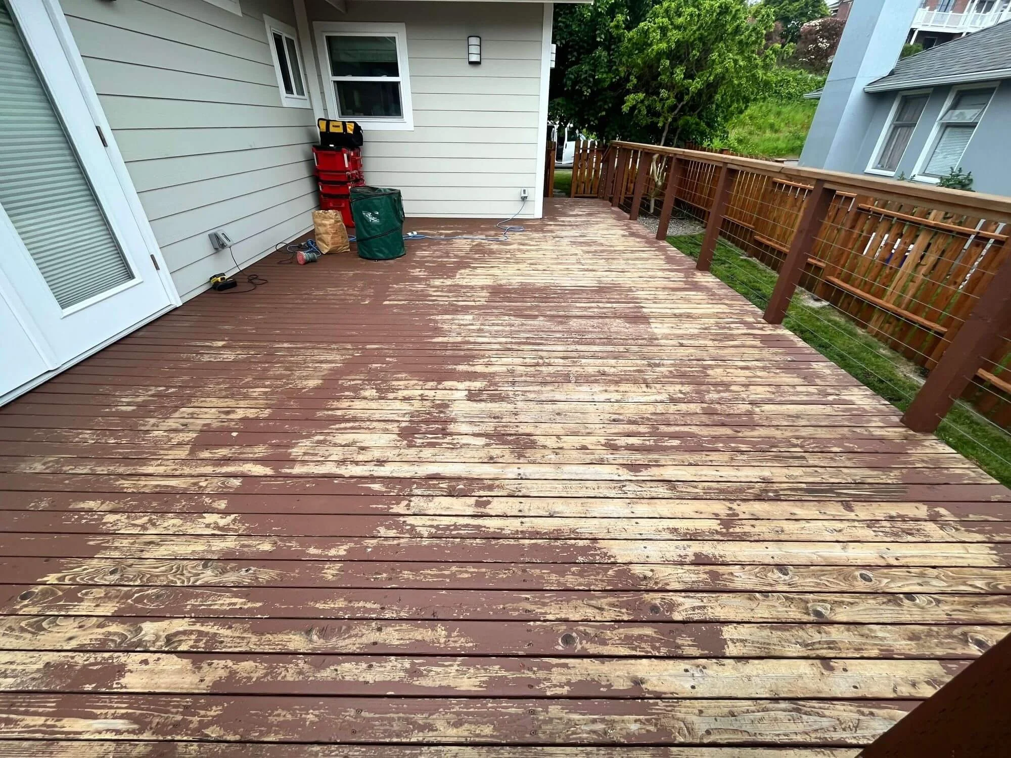 The deck refinishing project is underway for this West Seattle home. Gold Mountain Contracting to the rescue!