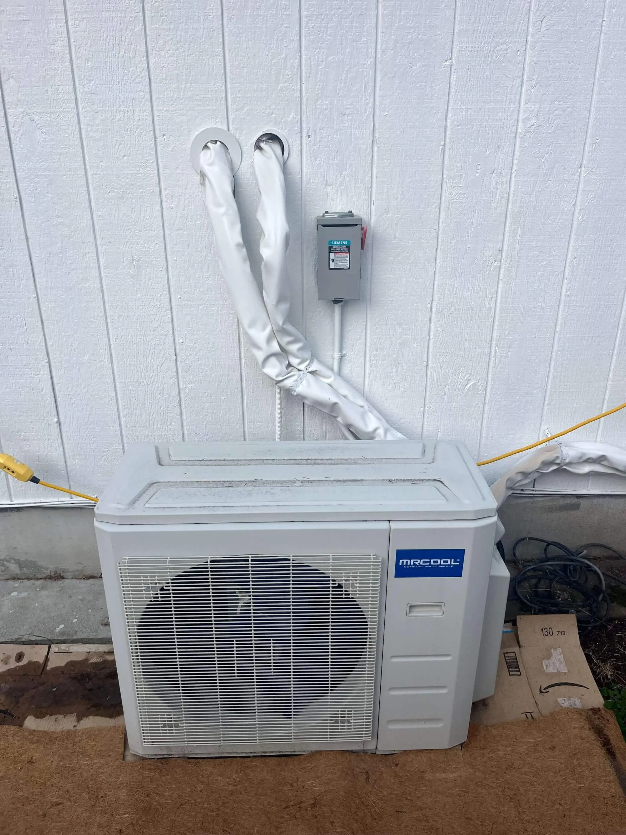 Outdoor view of a ductless mini split air conditioning system by Seattle Electrical Contractor, Gold Mountain Contracting.