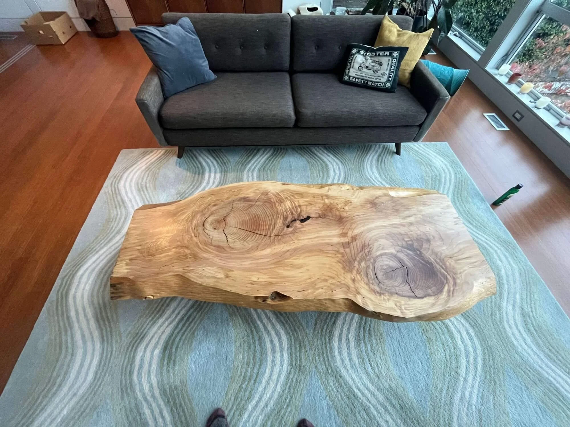 Close up view of the newly refinished live edge wood coffee table at a home in Magnolia, Seattle.