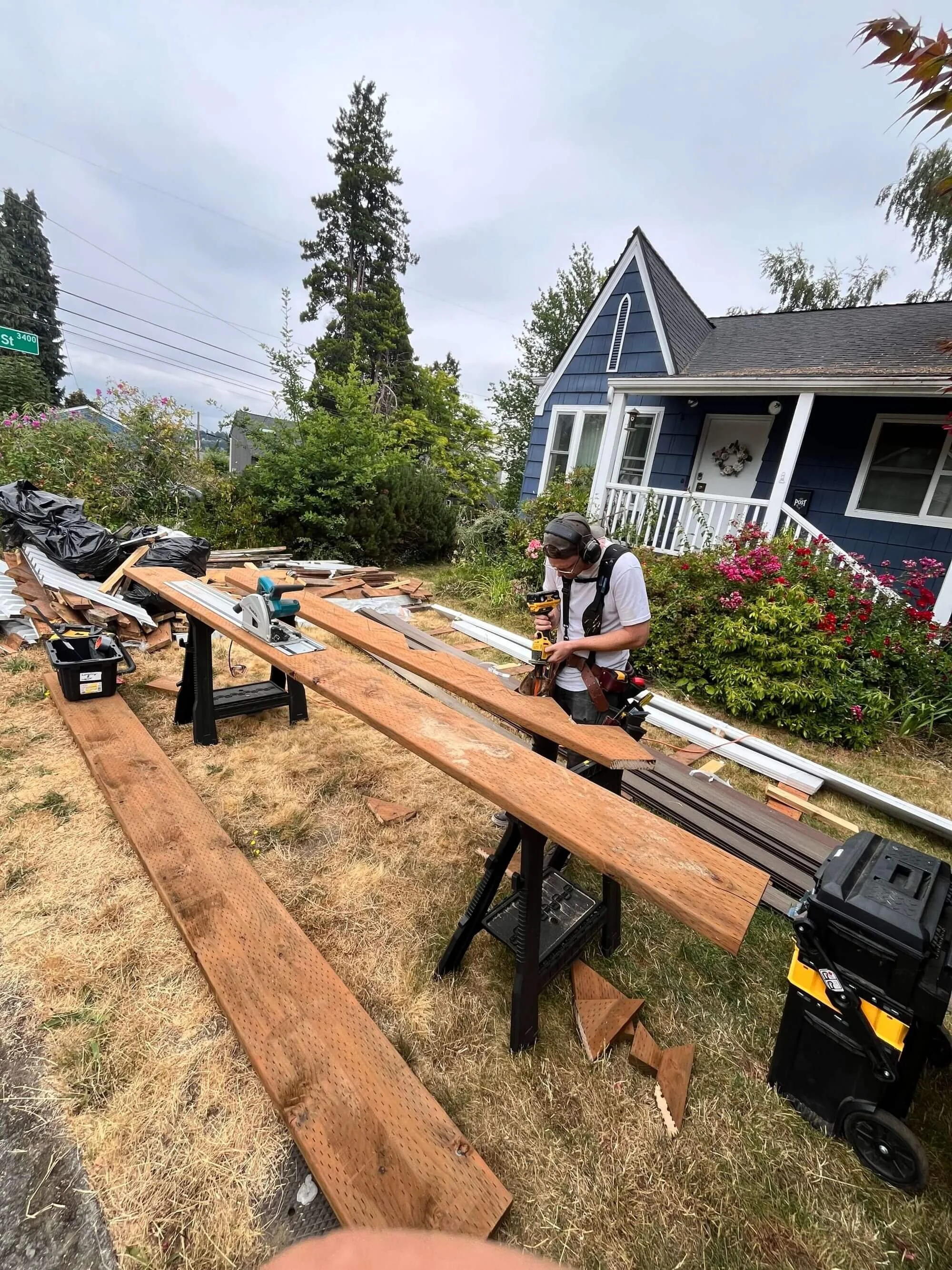 Another Gold Mountain Carpenter hard at work in the yard of a Queen Anne client where their deck is being renovated.