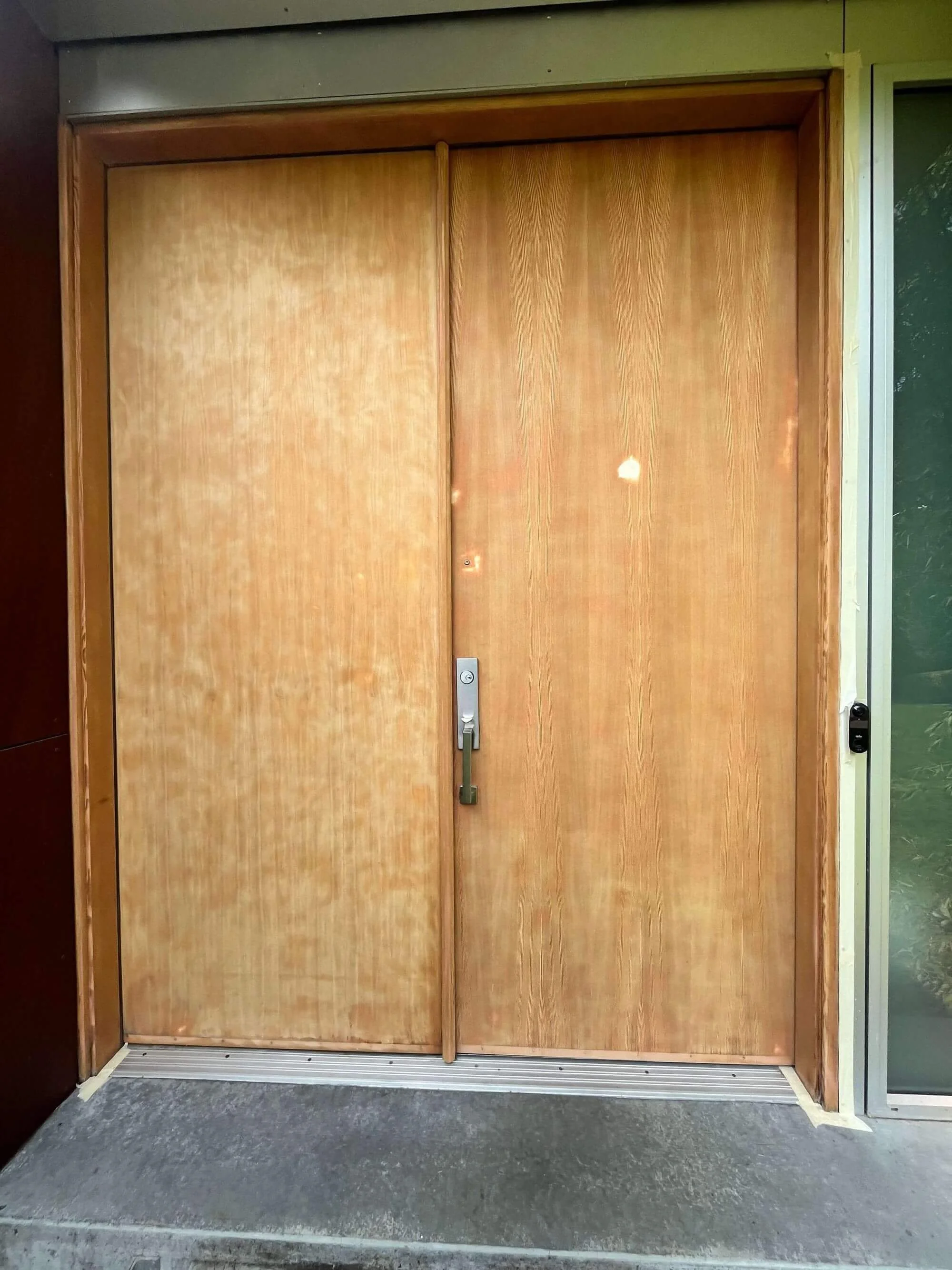 The original veneer on the doors of this Seattle home needed to be replaced with new fir veneers before refinishing them.