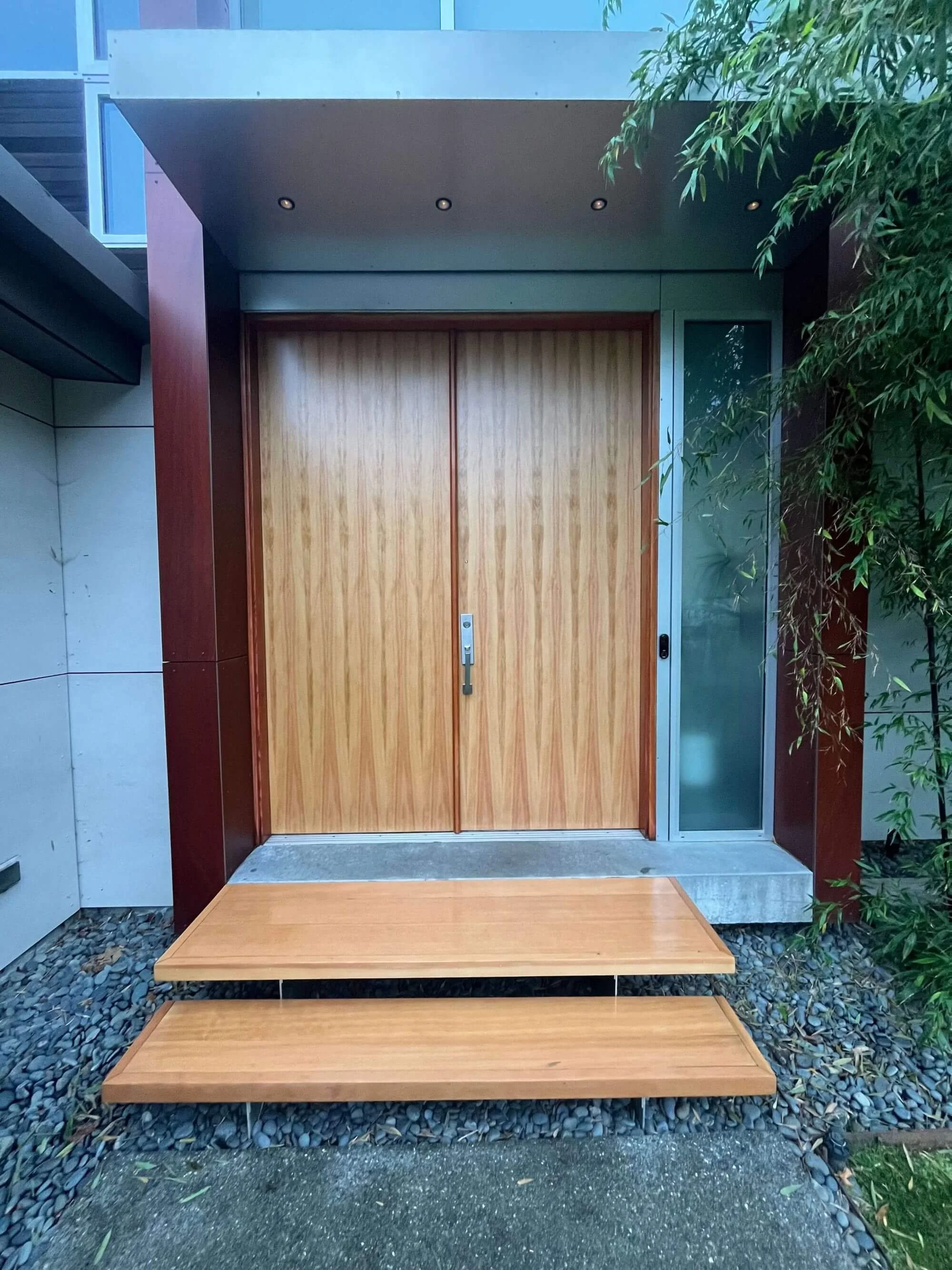 Beautiful wood front door and steps in Magnolia, Seattle refinished by Gold Mountain Contracting.