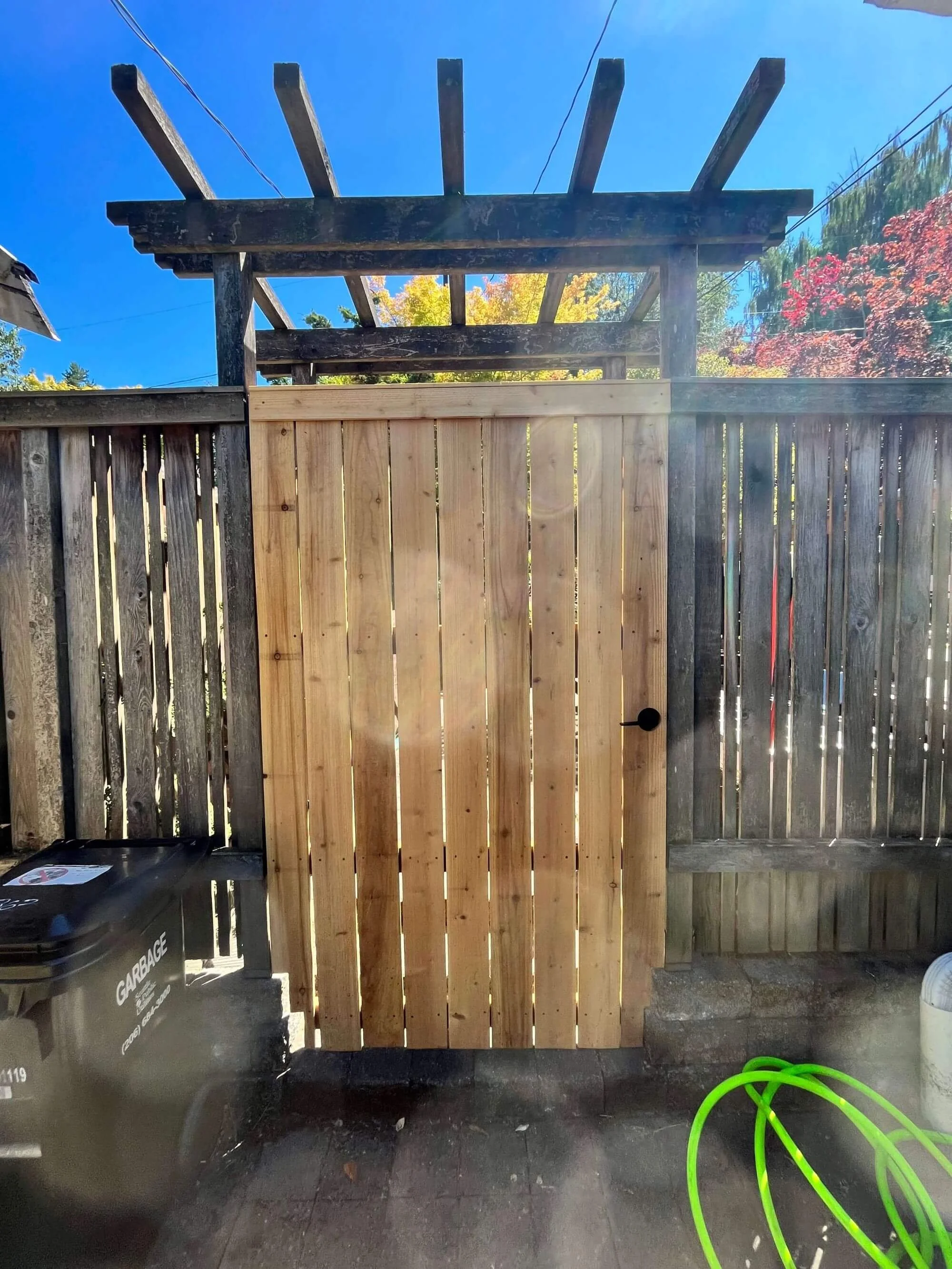 The opposite side of a new cedar gate, custom built by Seattle Fence Contractor, Gold Mountain Contracting.
