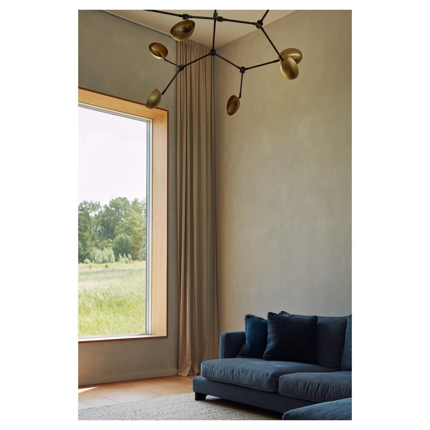 Interior view of our completed low energy house at Graven Hill. The design embraces the east/west orientation and uses the changing light to define spaces and enrich the day to day use do the house. Elevating the main sitting room to the first floor 