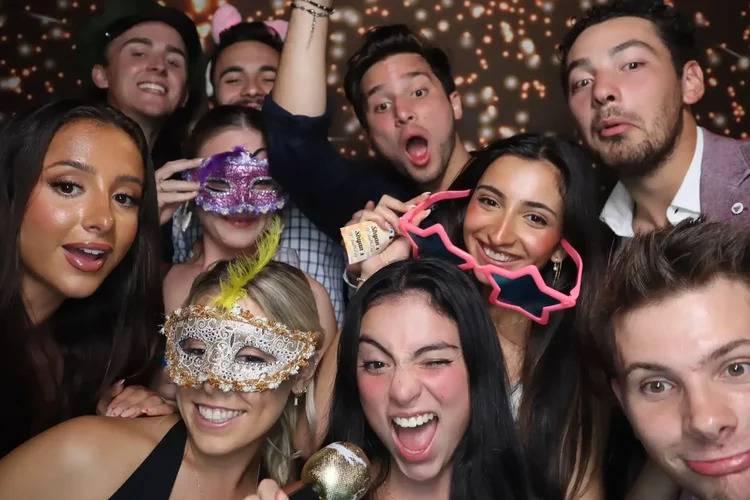 Friends posing with props in a party photo booth available for Dandenong celebrations