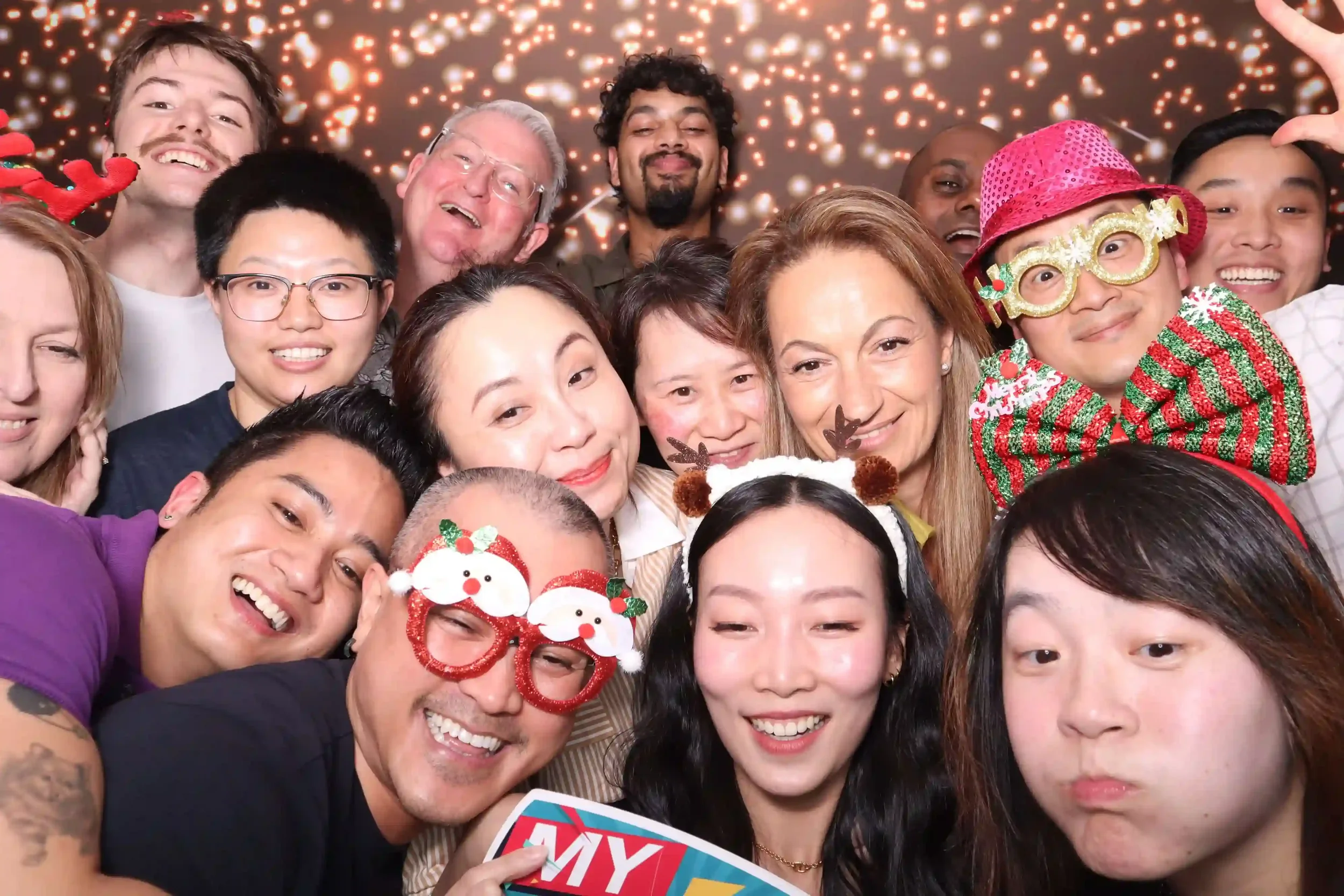 Group selfie with fun props using Pixel Booth’s open-air photo booth at a Melbourne corporate Christmas event.
